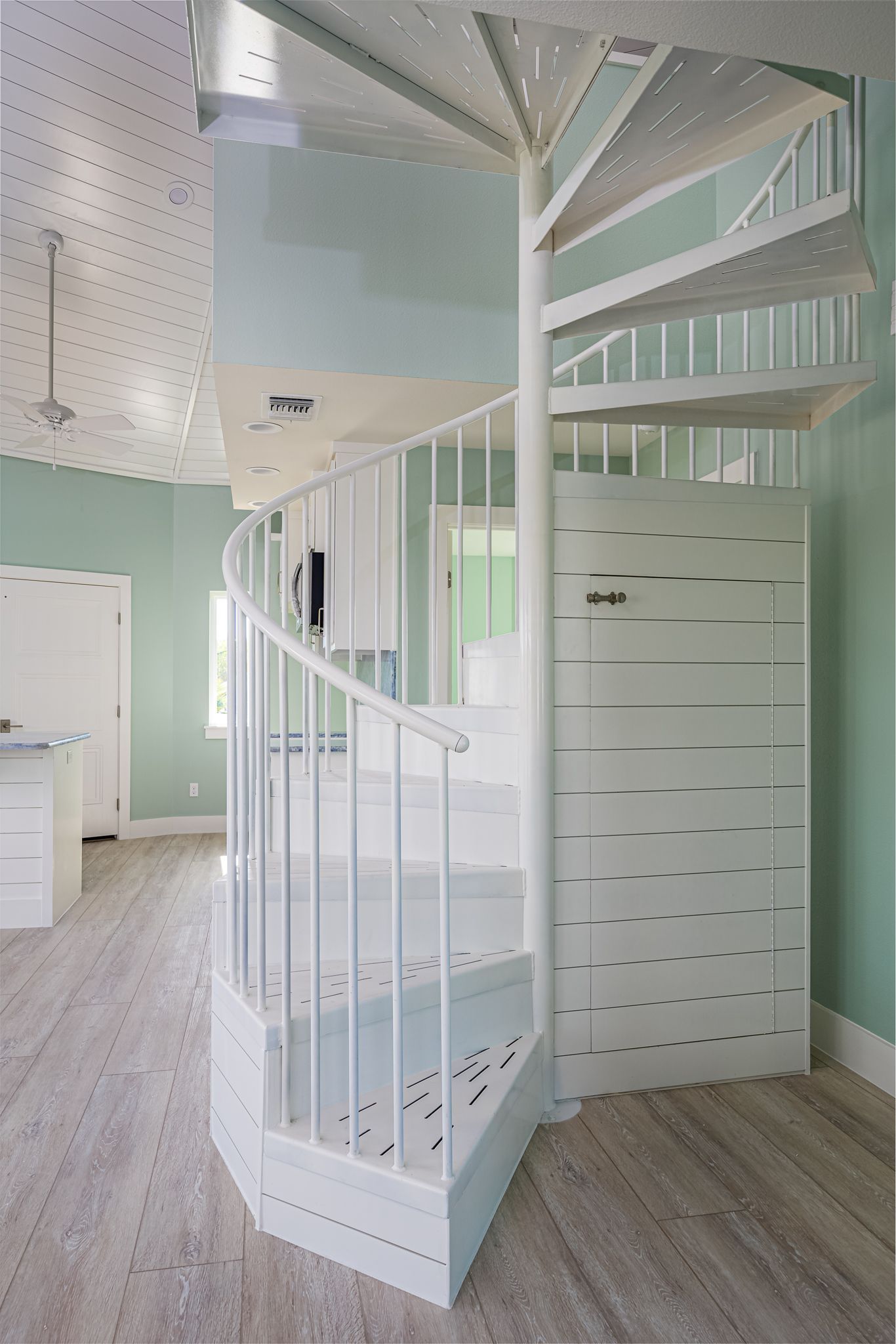 There is a spiral staircase in the middle of the room.