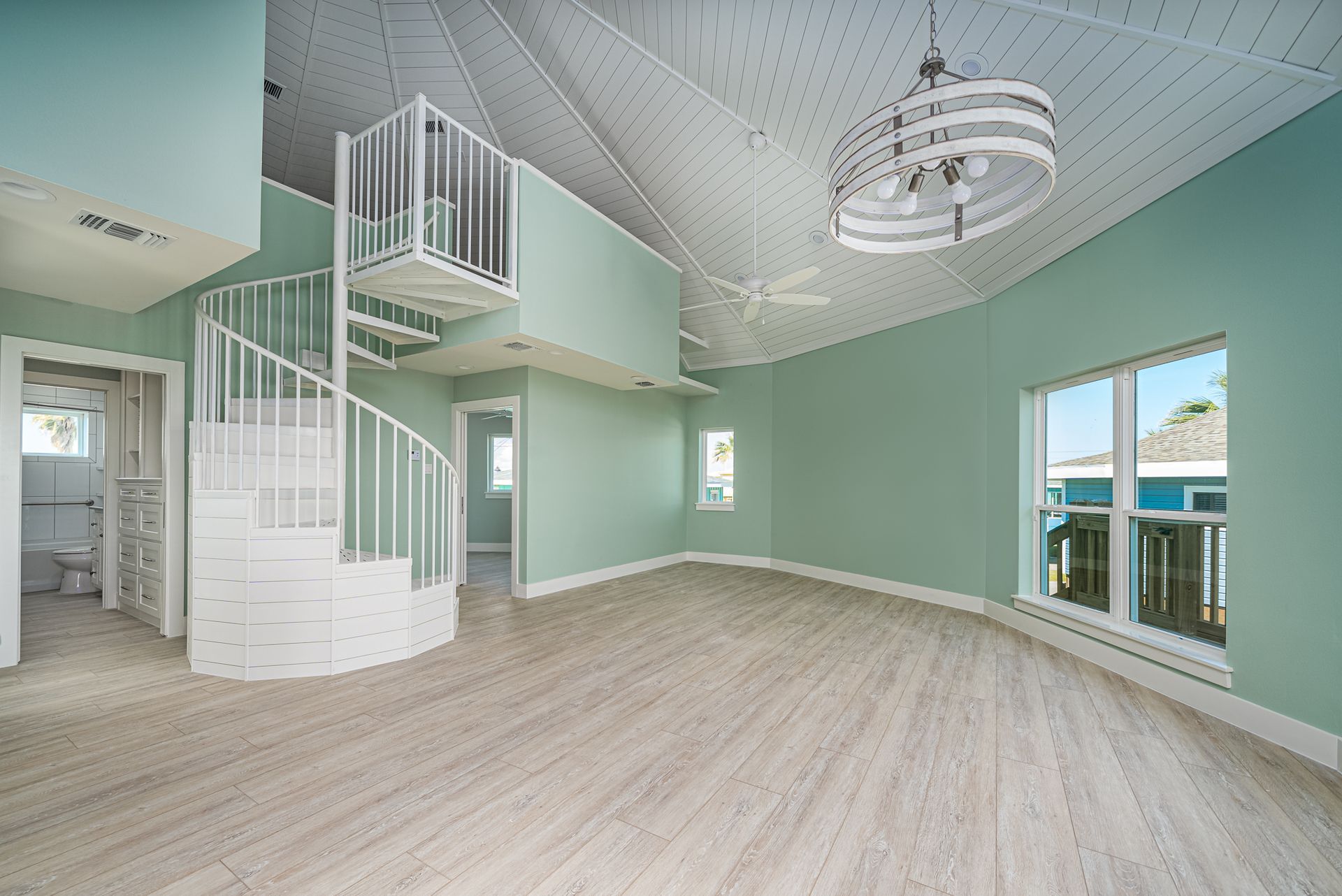 There is a spiral staircase in the middle of the room.