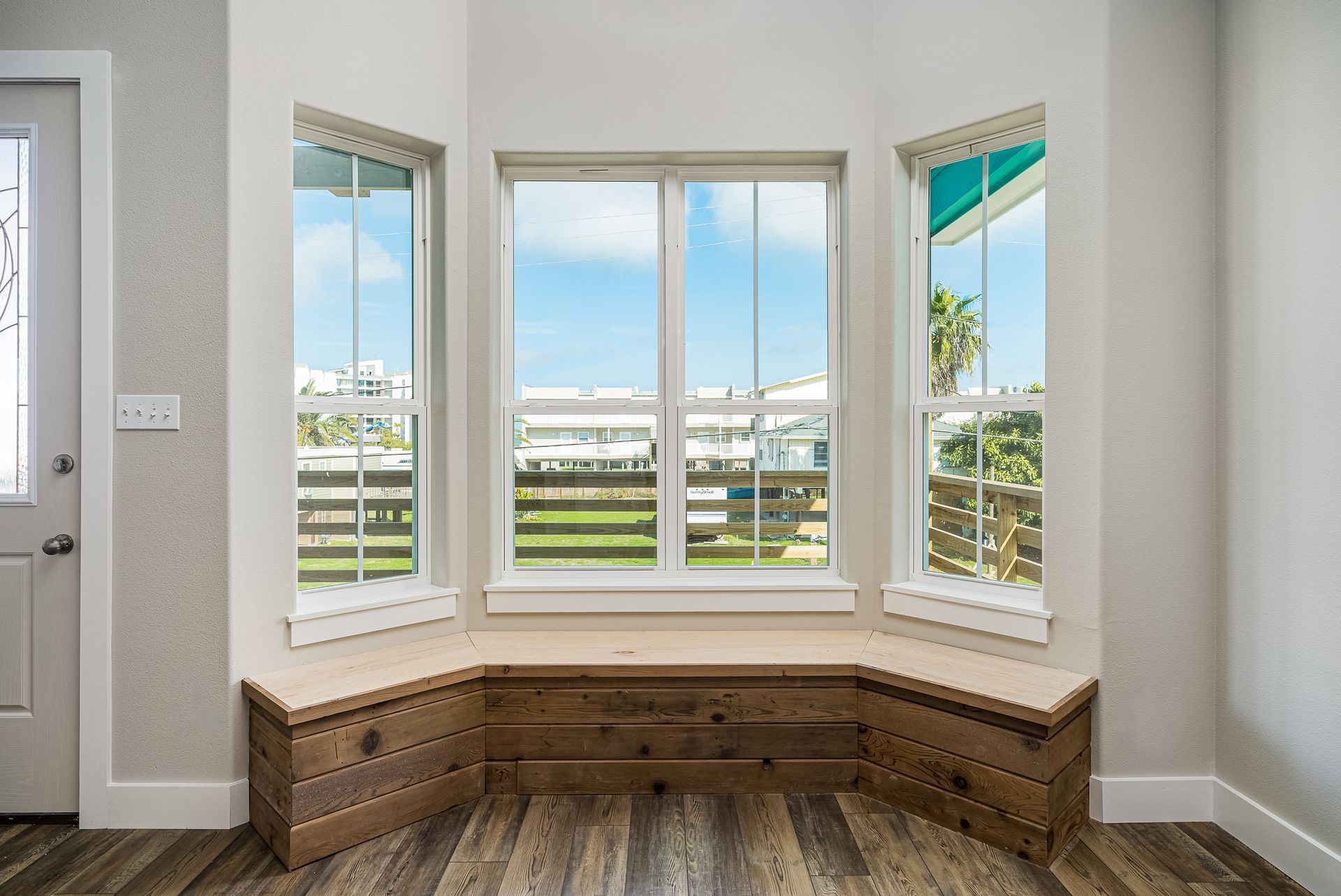 There is a window seat in the corner of the room.