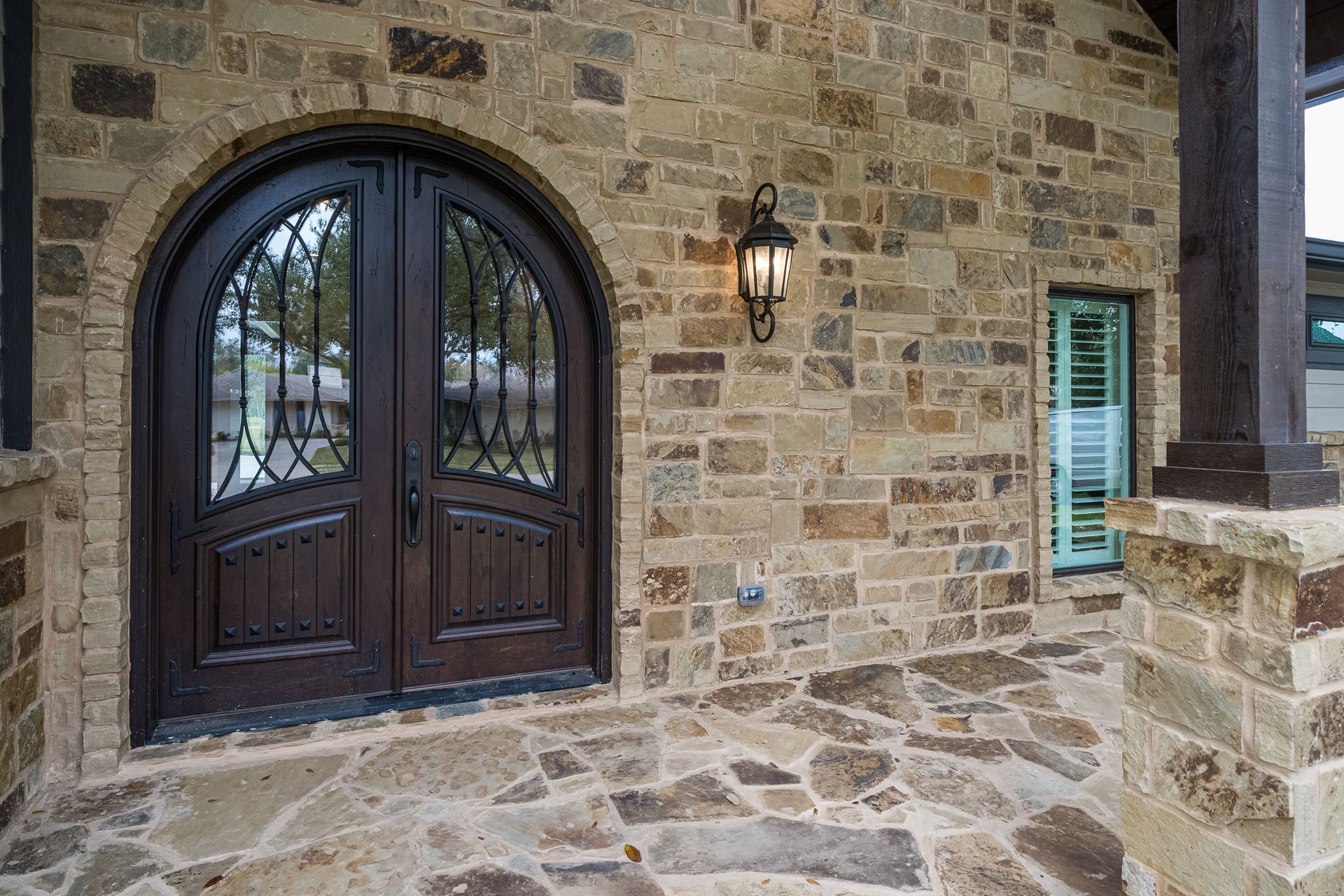 A brick building with a wooden door and a stone floor.