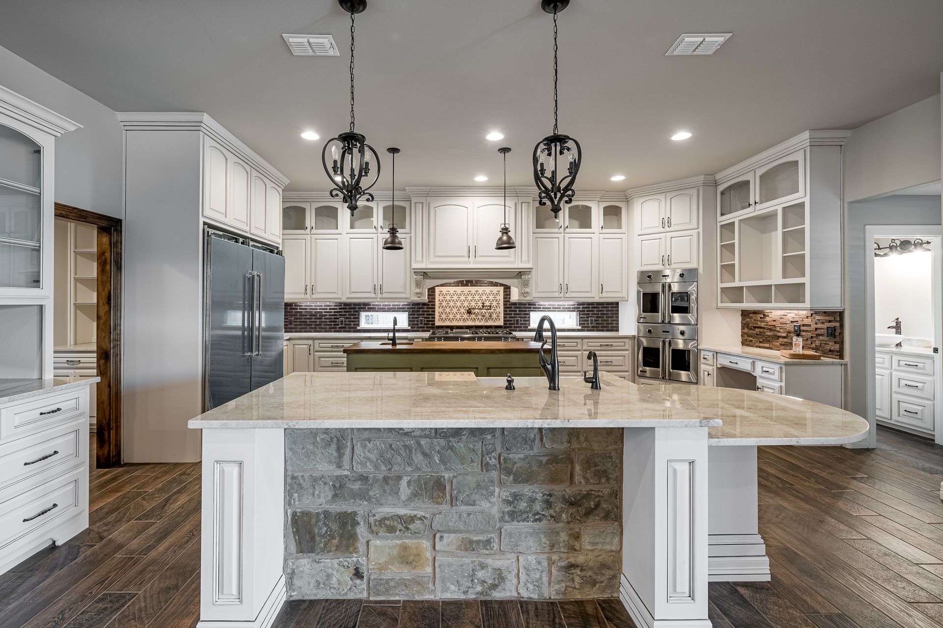 A large kitchen with a large island in the middle.