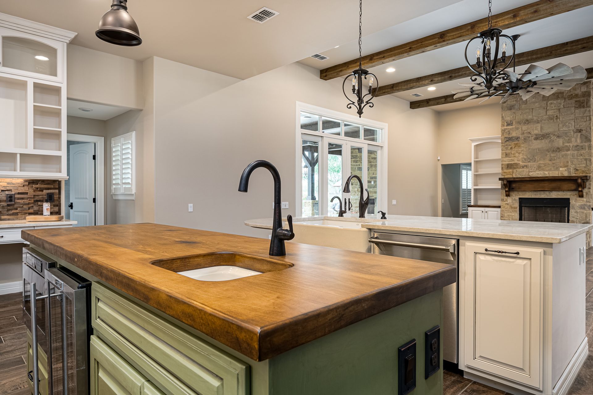 A kitchen with a large island and a sink.