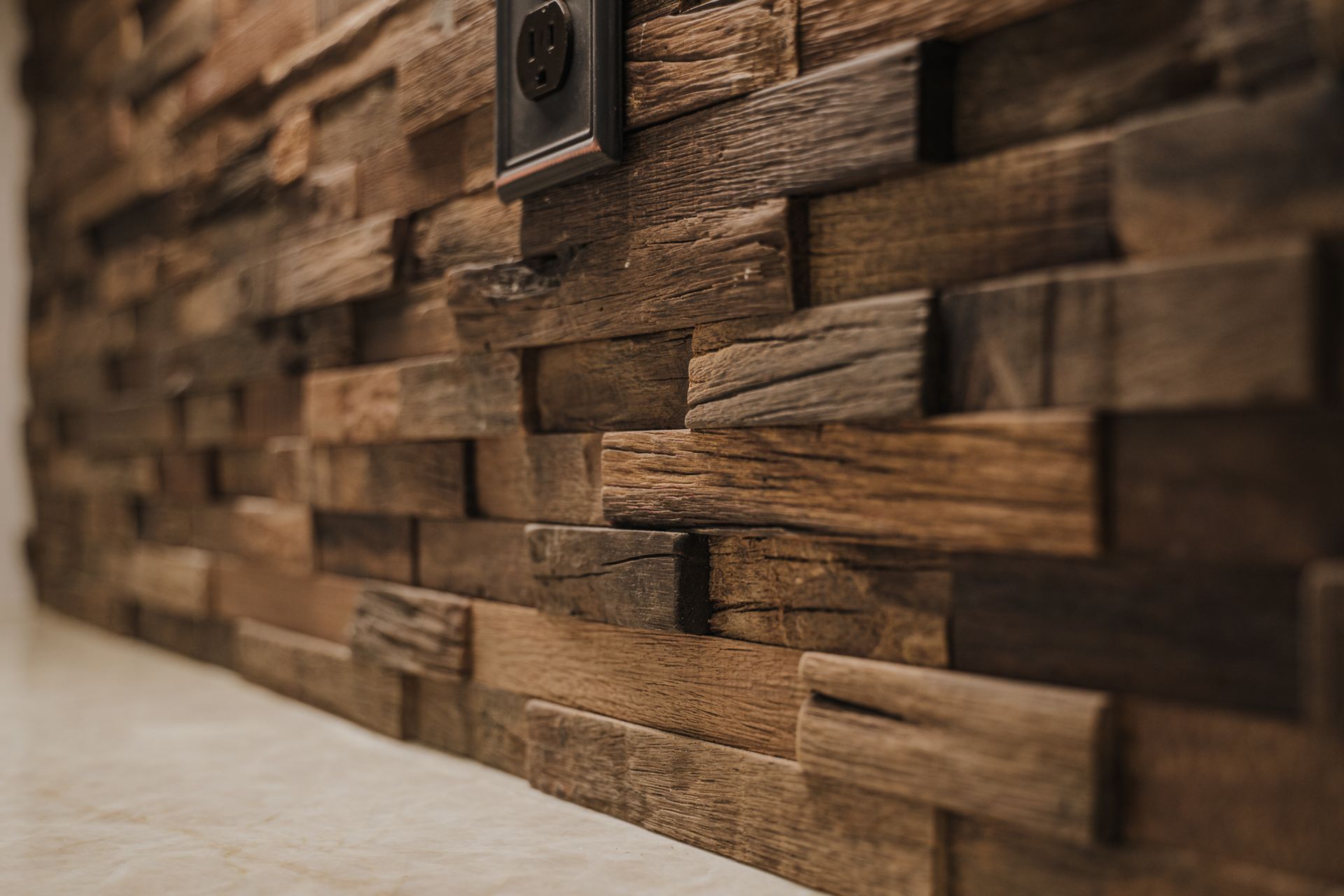 A close up of a wooden wall with a light switch on it.