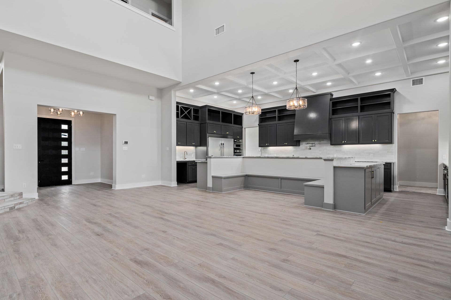 A kitchen and living room in a house with hardwood floors.