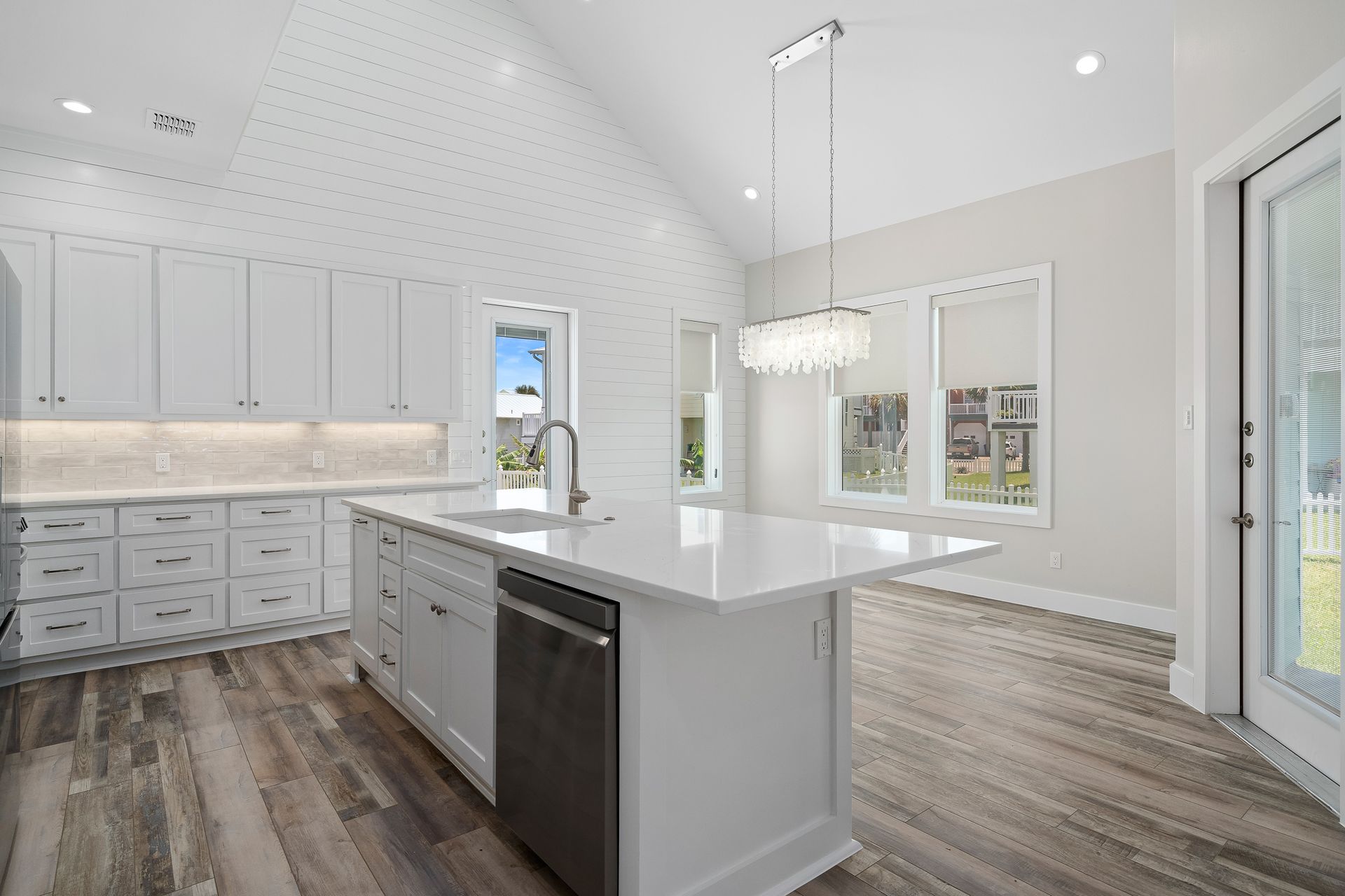 A kitchen with a large island and stainless steel appliances.