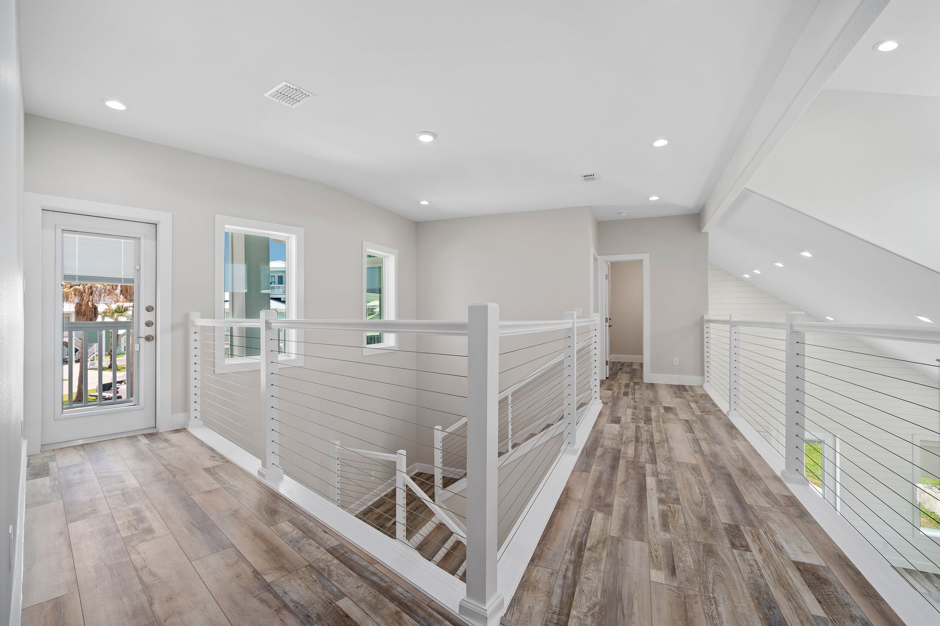 A hallway with stairs leading up to the second floor of a house.