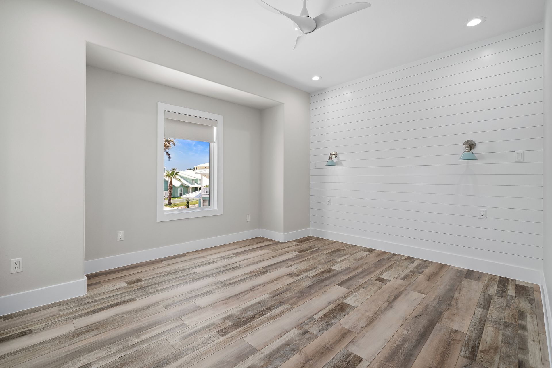 There is a ceiling fan in the room and a window.