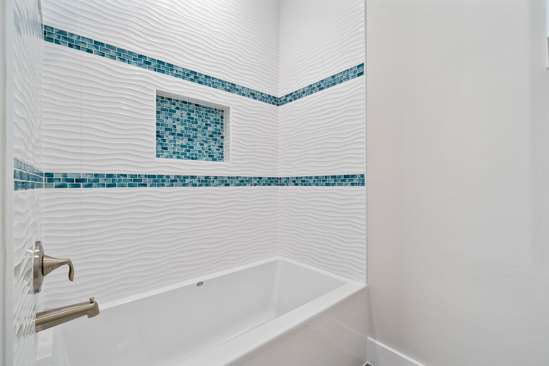 A bathroom with a bathtub and a shower.