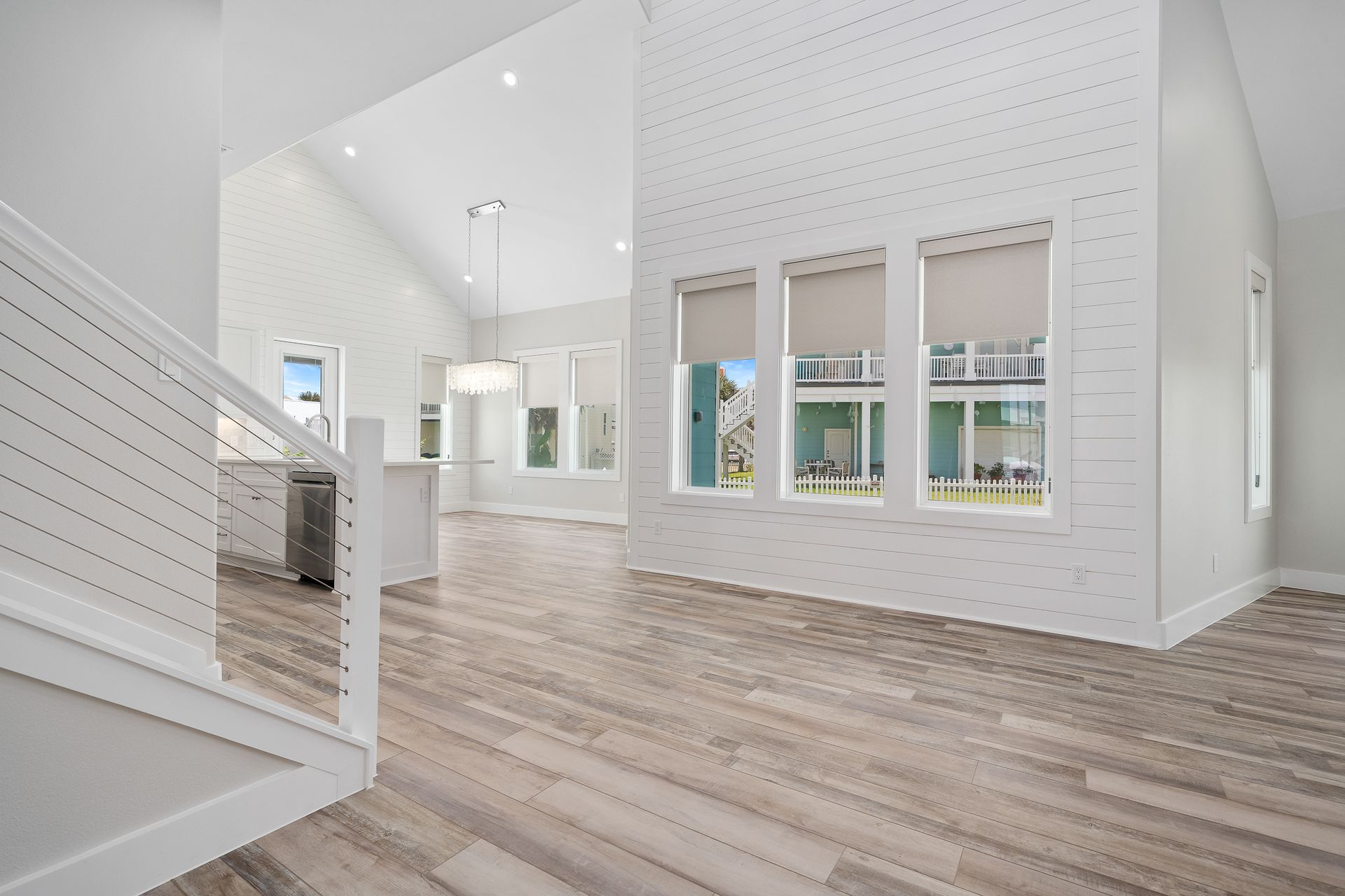 A living room with hardwood floors and white walls