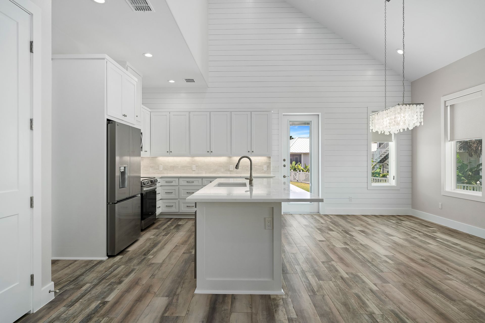 A kitchen with a large island and stainless steel appliances.
