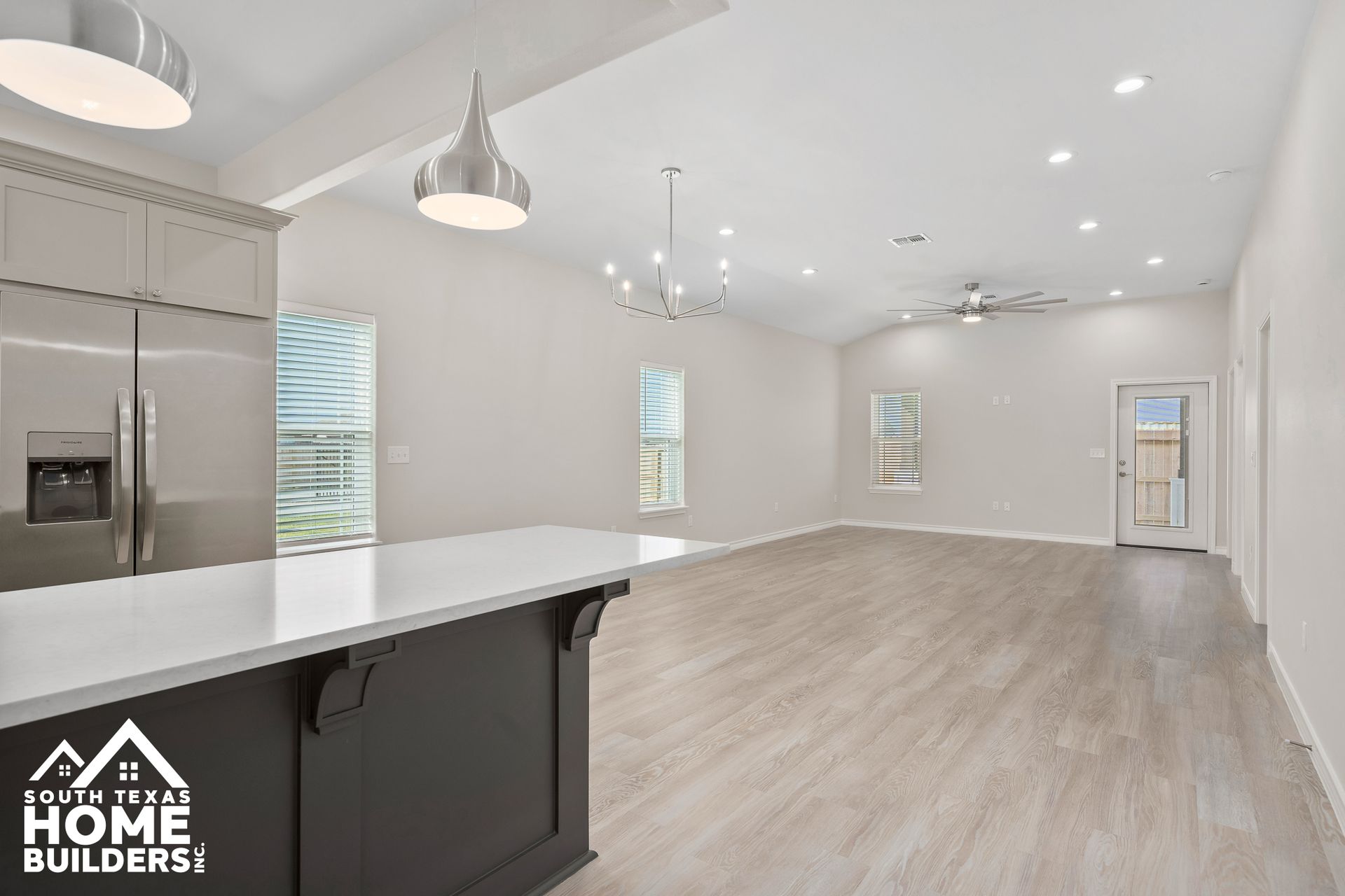 Modern home interior with light wood floors, gray walls, and open layout.