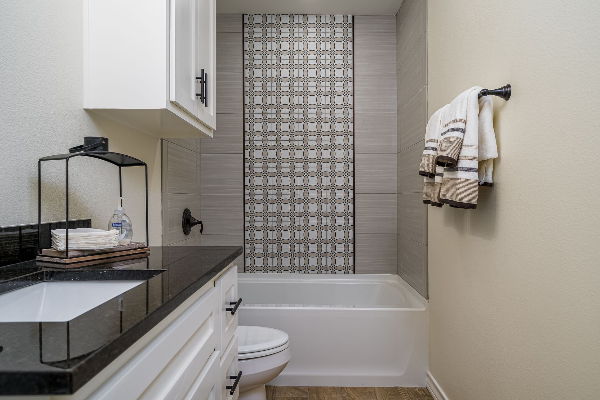 A bathroom with a toilet , sink , bathtub and shower.