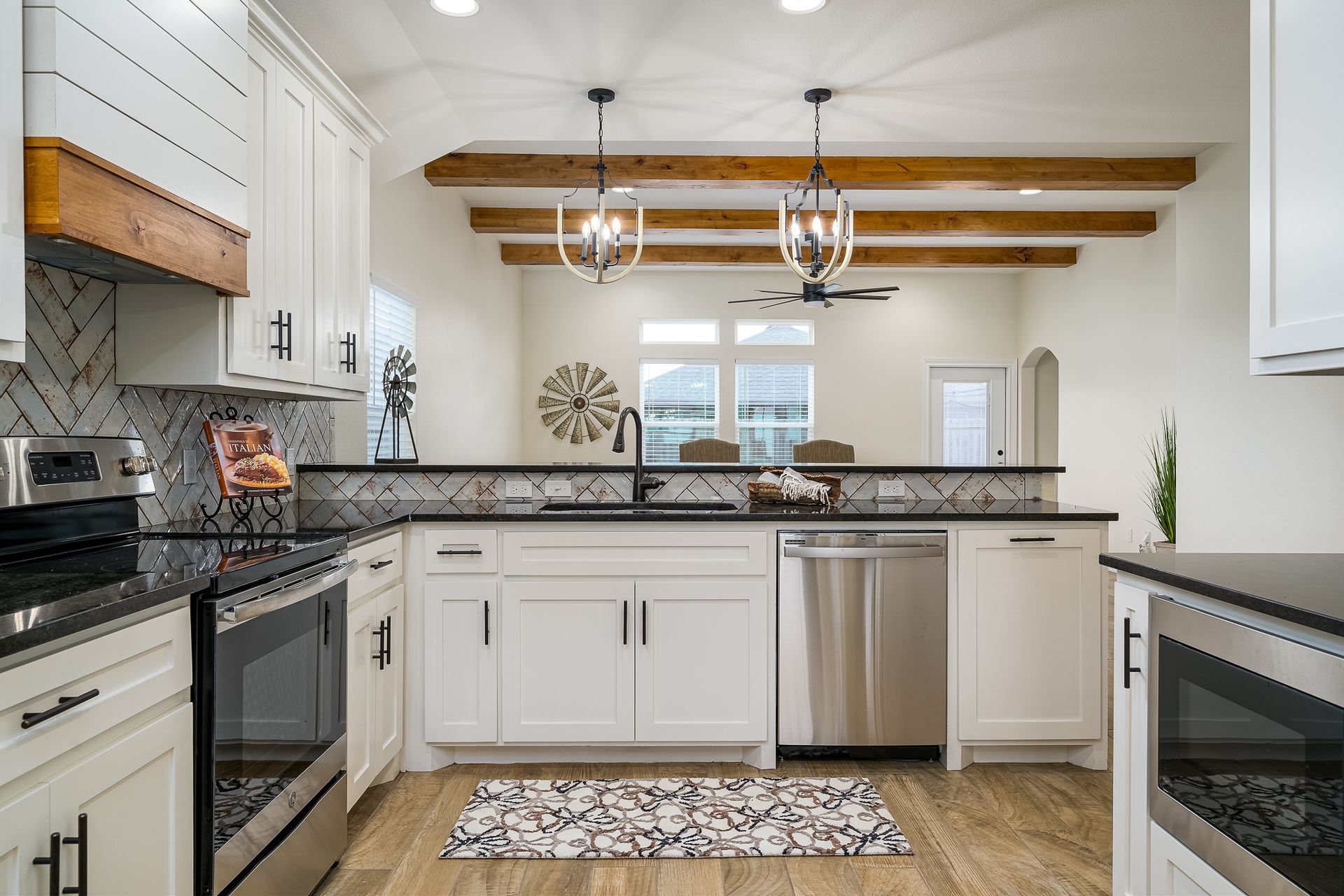A kitchen with white cabinets and stainless steel appliances.