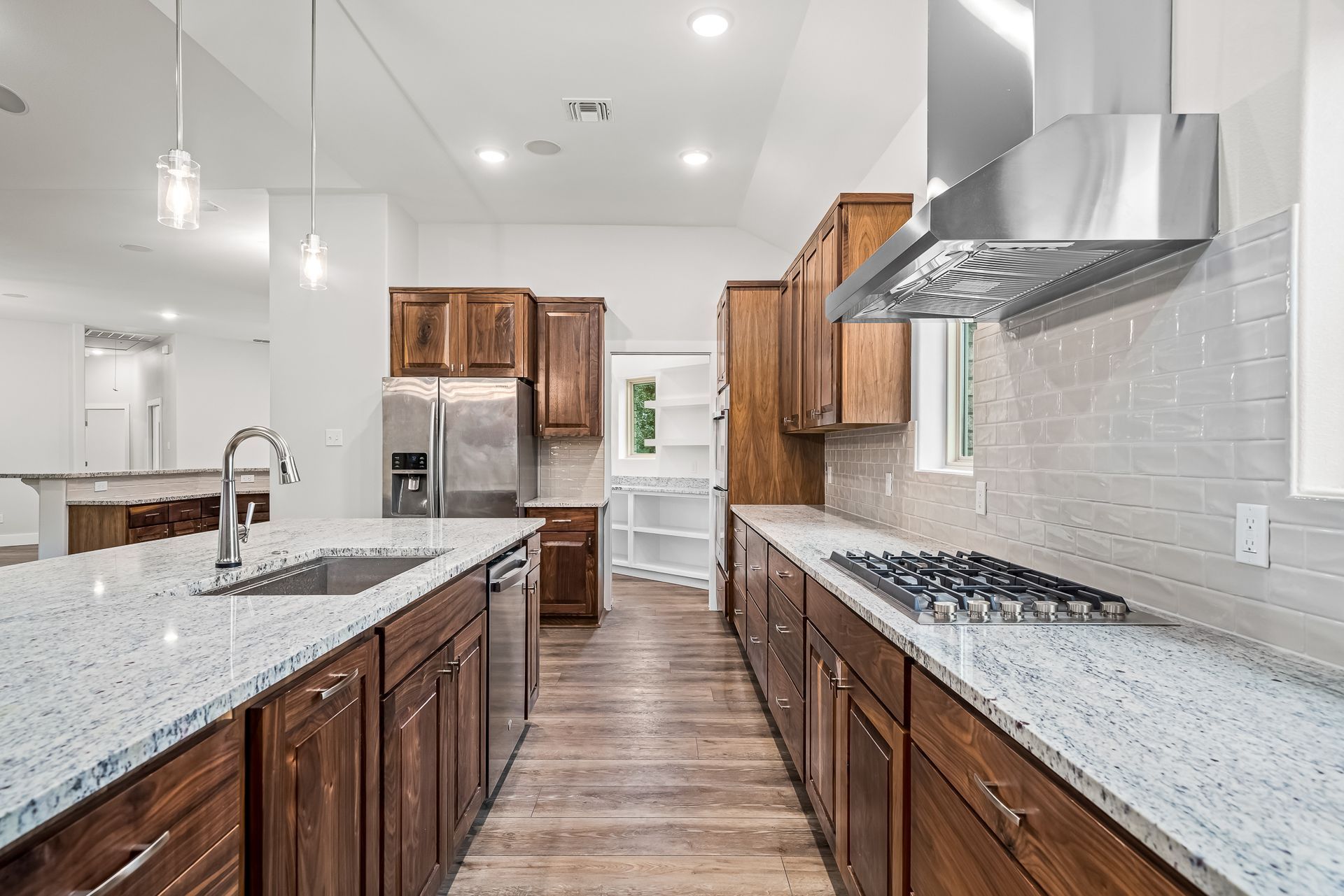 A kitchen with stainless steel appliances and granite counter tops.