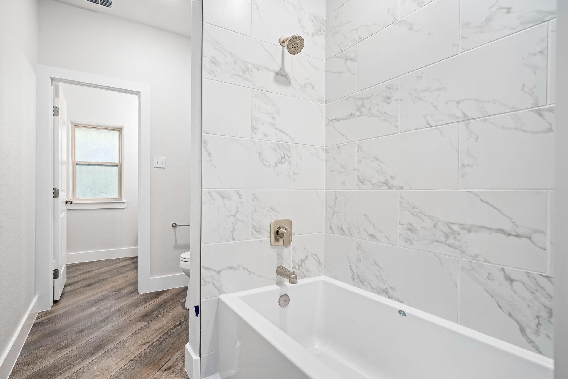 A bathroom with a bathtub and a shower.