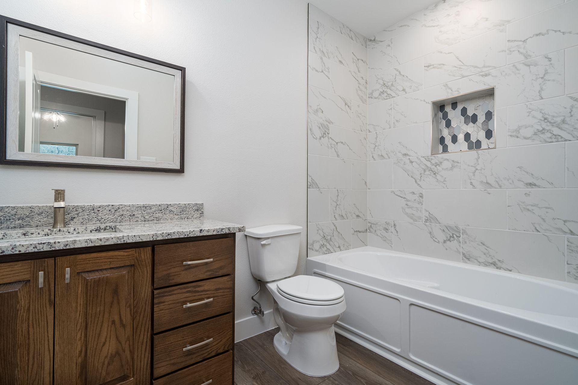 A bathroom with a toilet , sink , and bathtub.