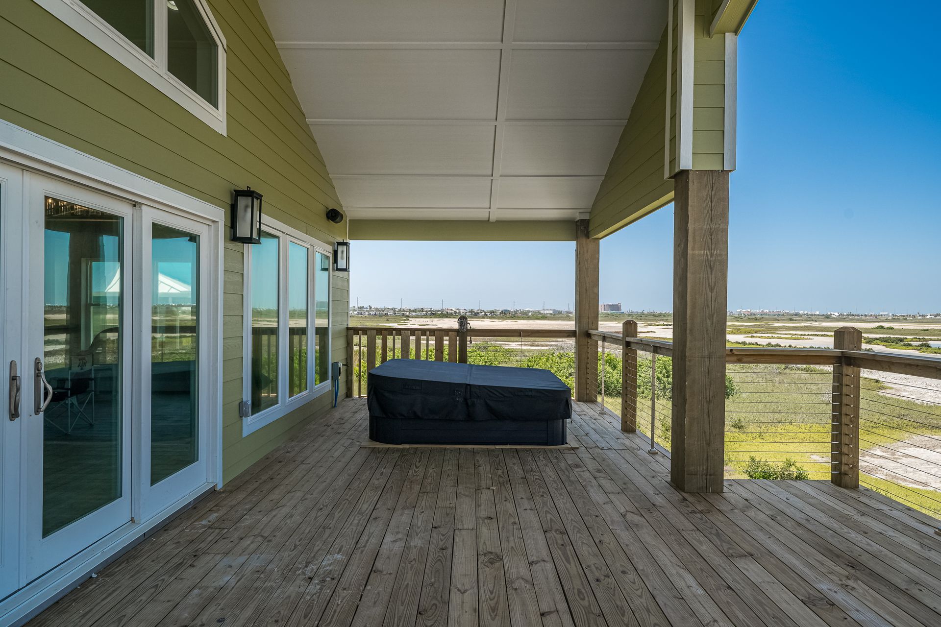 There is a hot tub on the deck of a house.