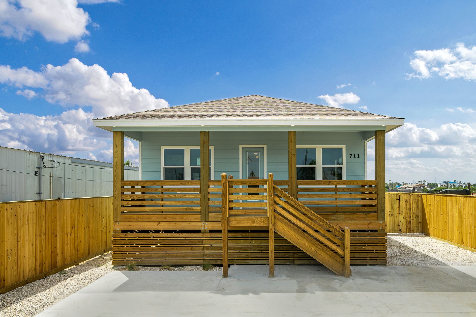 A small house with a wooden deck and stairs