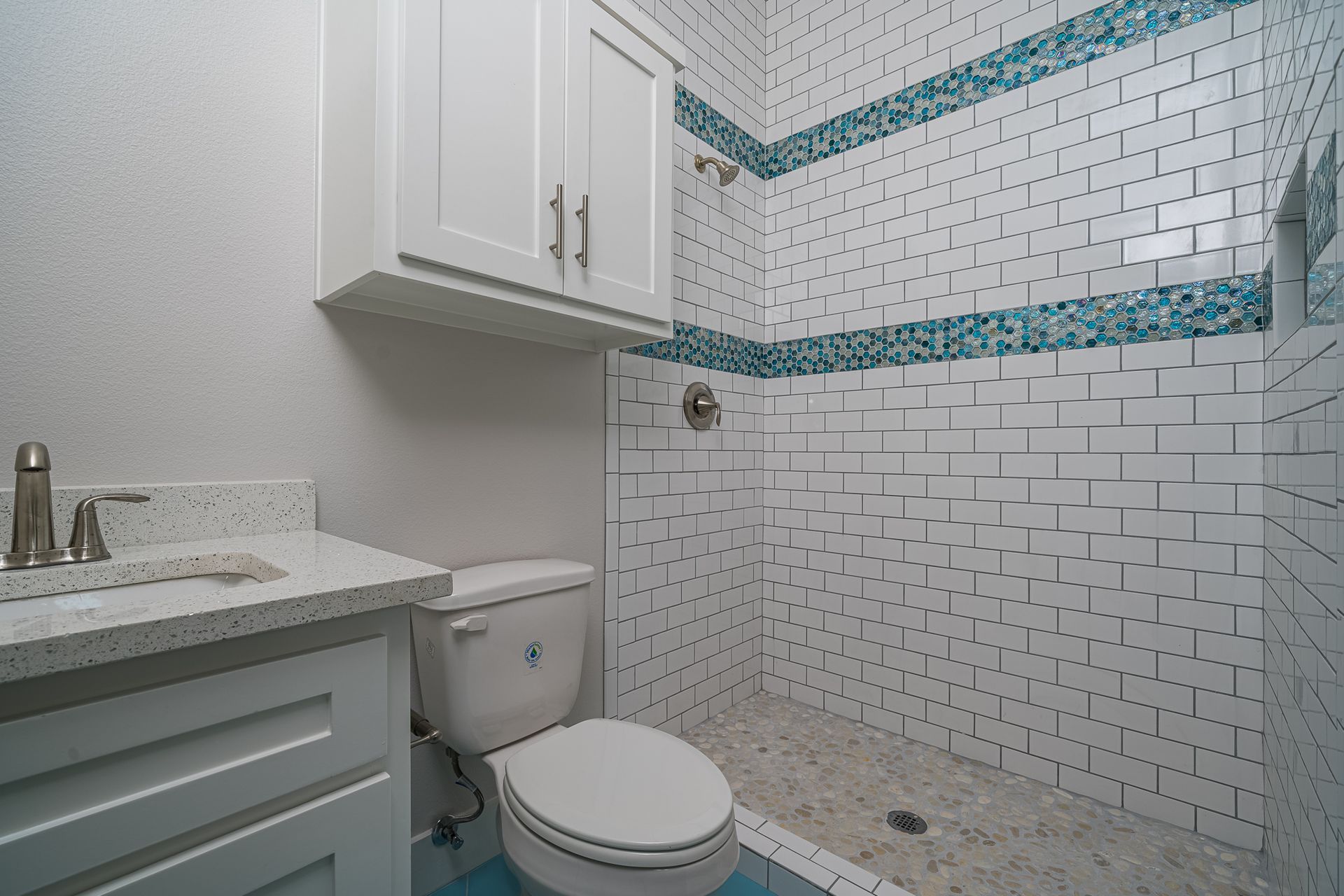 A bathroom with a toilet a sink and a shower