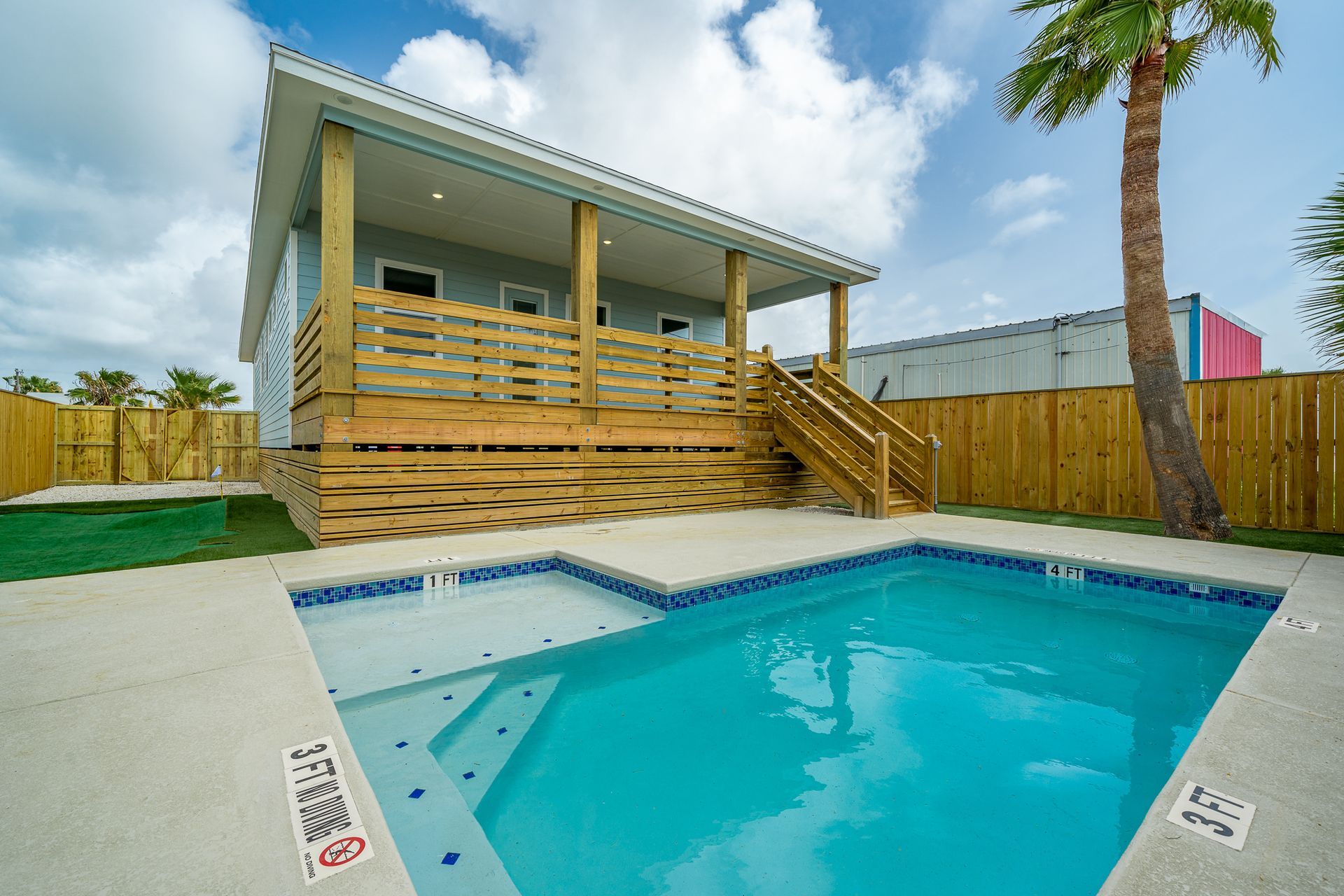 A house with a swimming pool in front of it