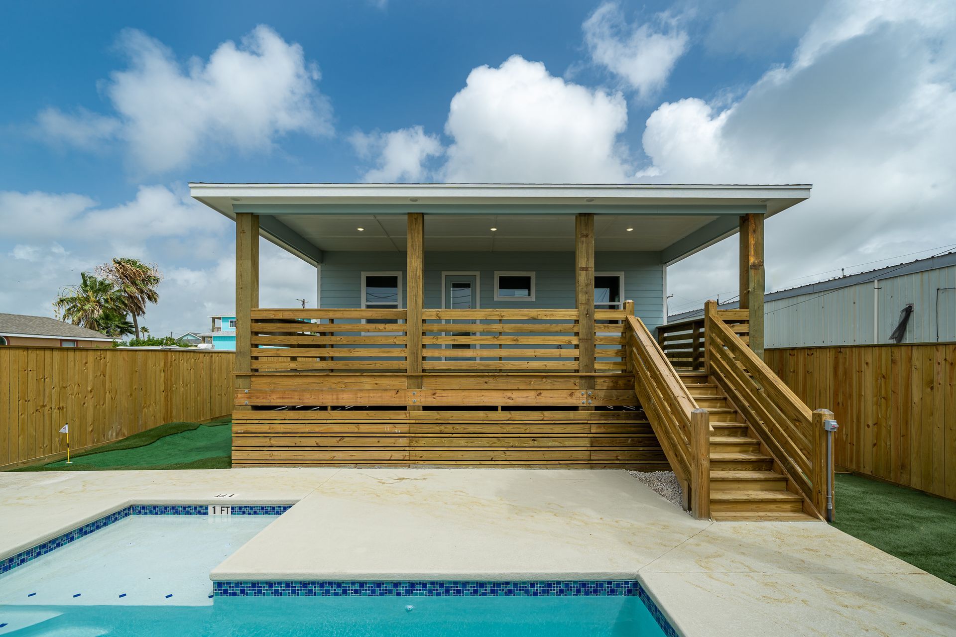 A house with a swimming pool in front of it
