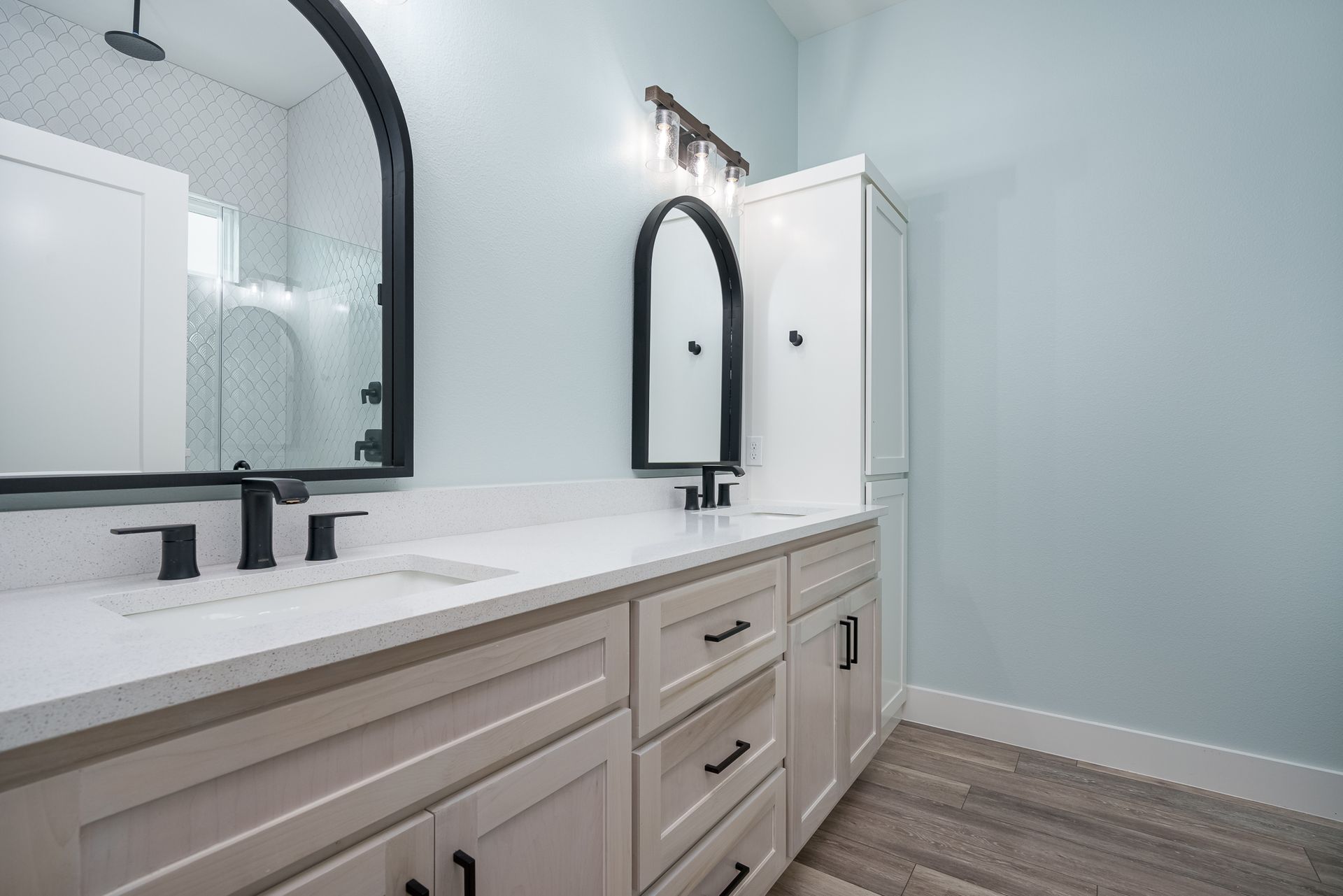 A bathroom with two sinks and two mirrors.