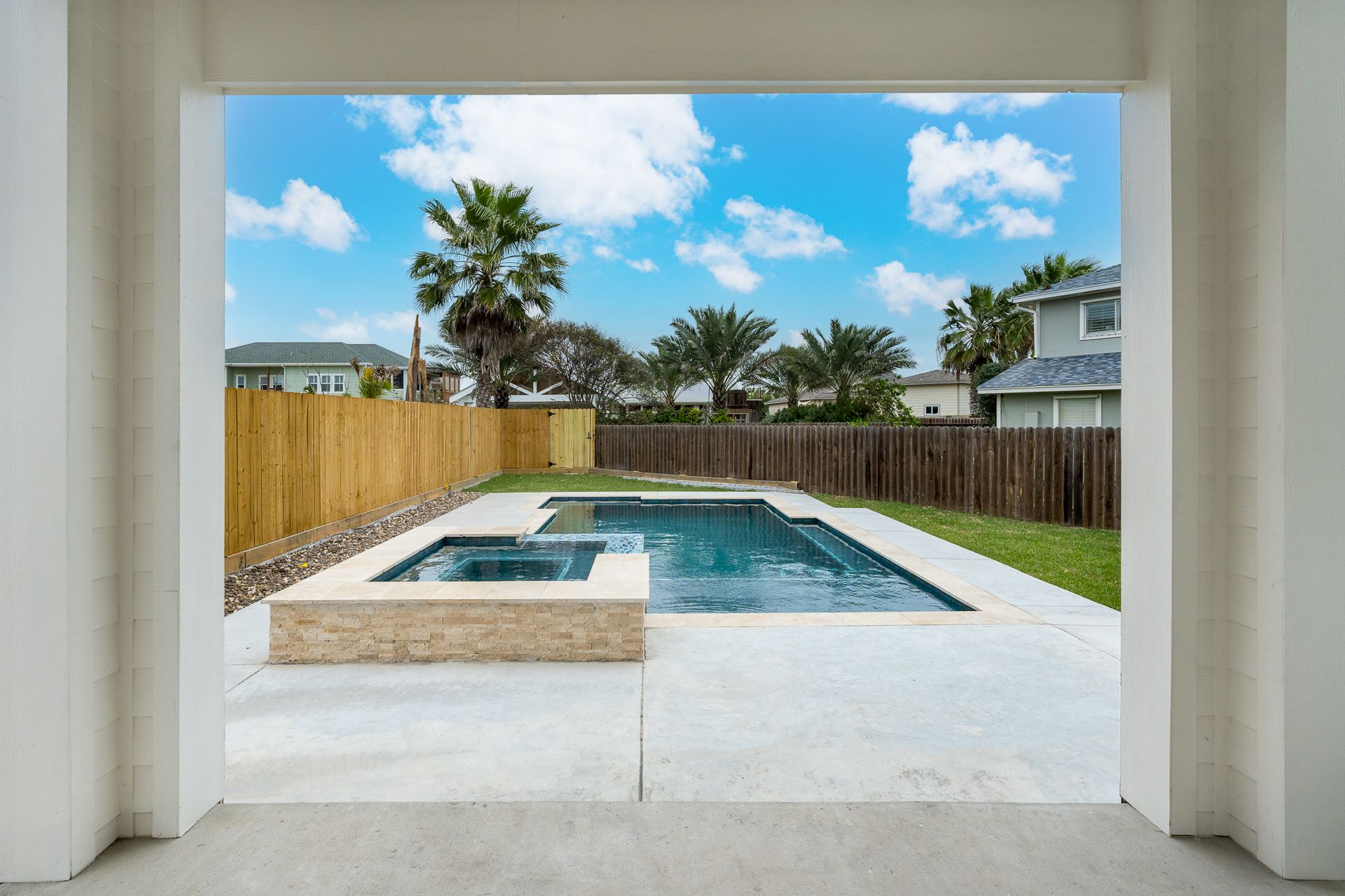 A view of a swimming pool from a garage door