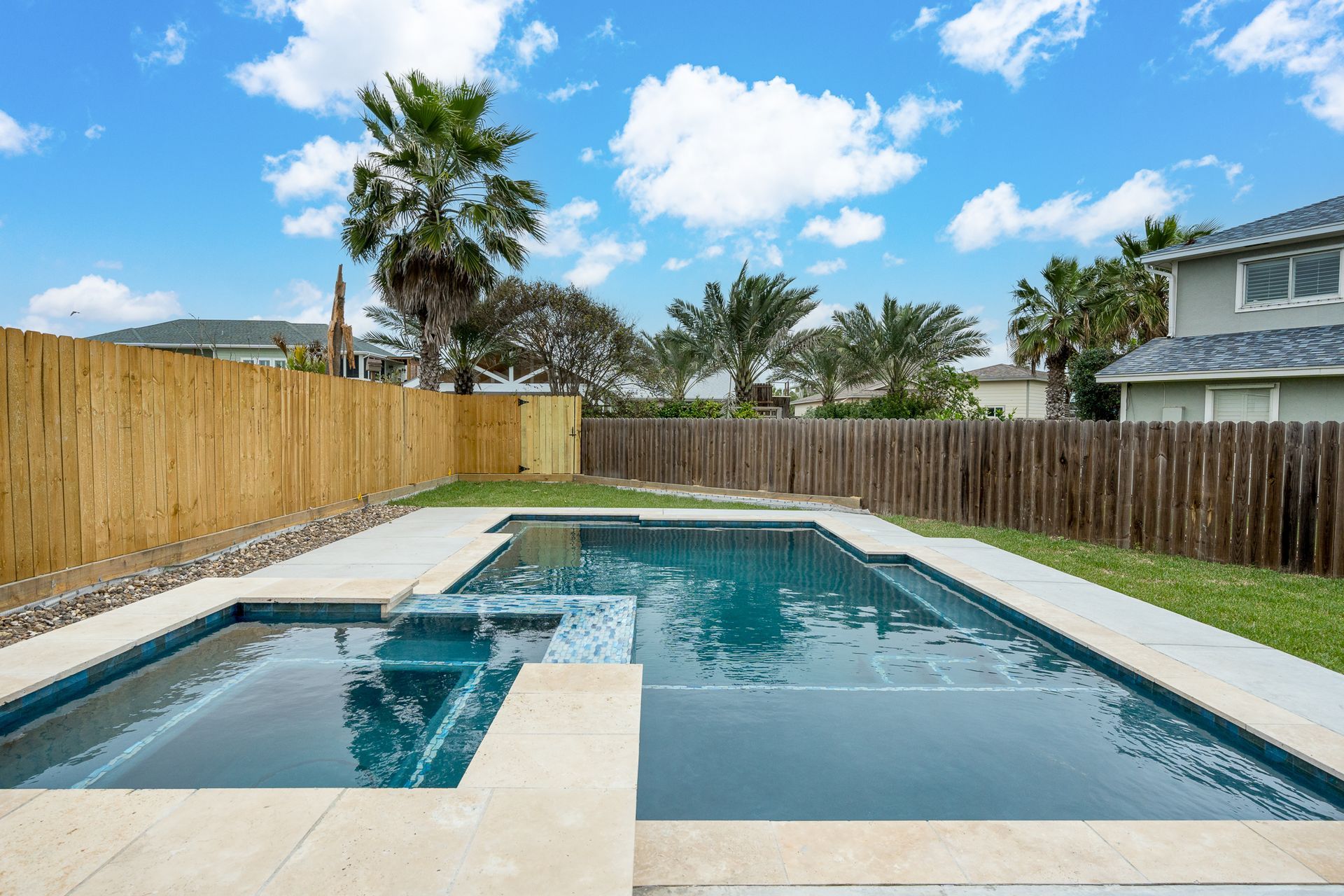 A large swimming pool in the backyard of a house