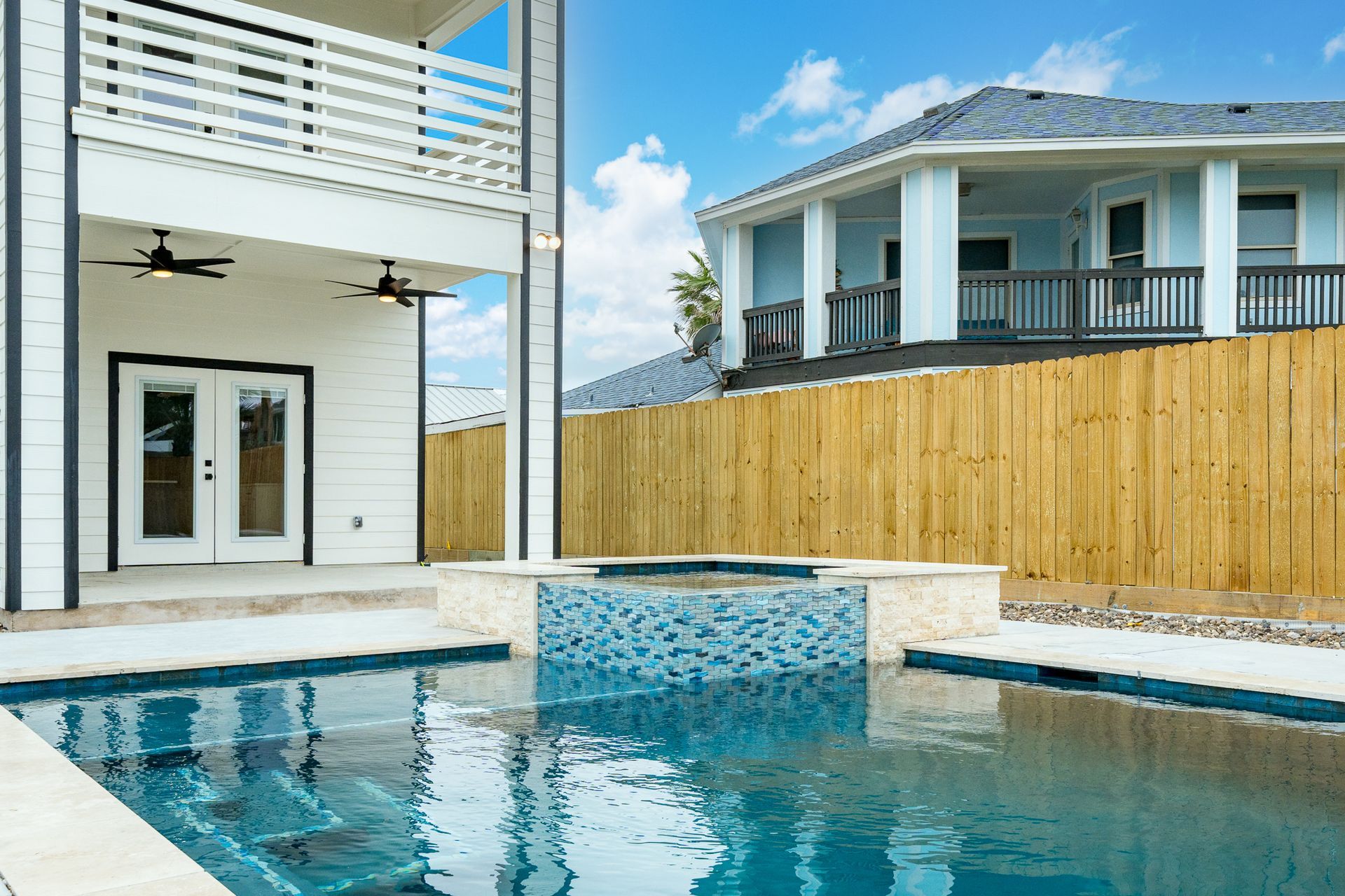 A large house with a swimming pool in front of it
