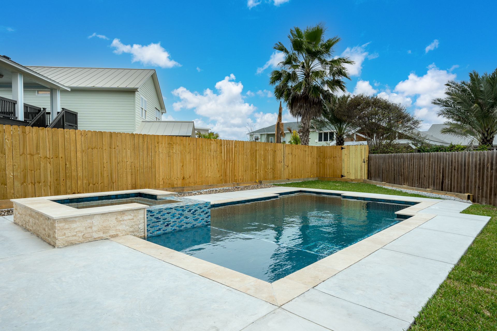 A large swimming pool in the backyard of a house