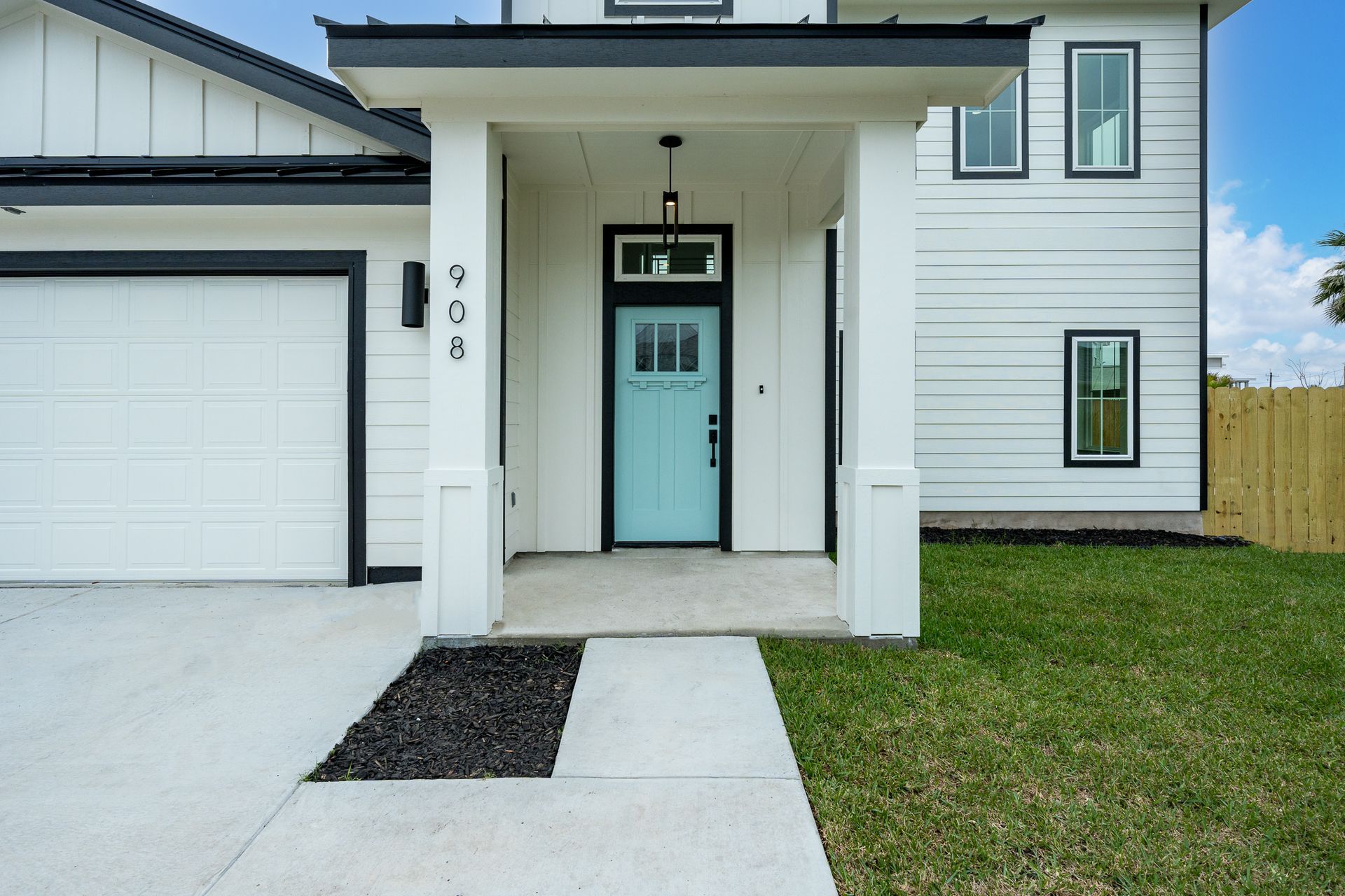 A white house with a blue door and black trim
