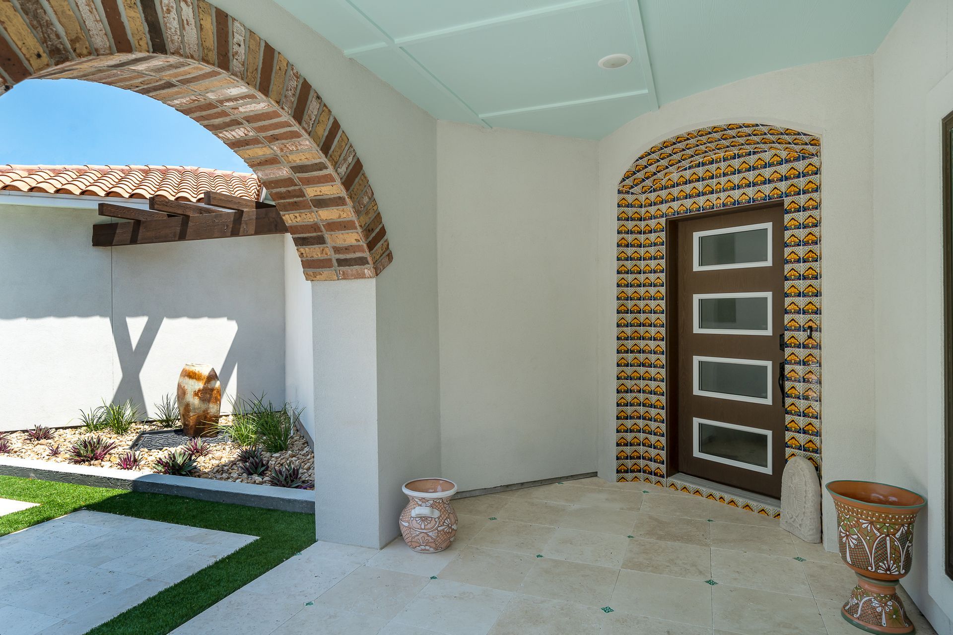 The front door of a house with a brick archway