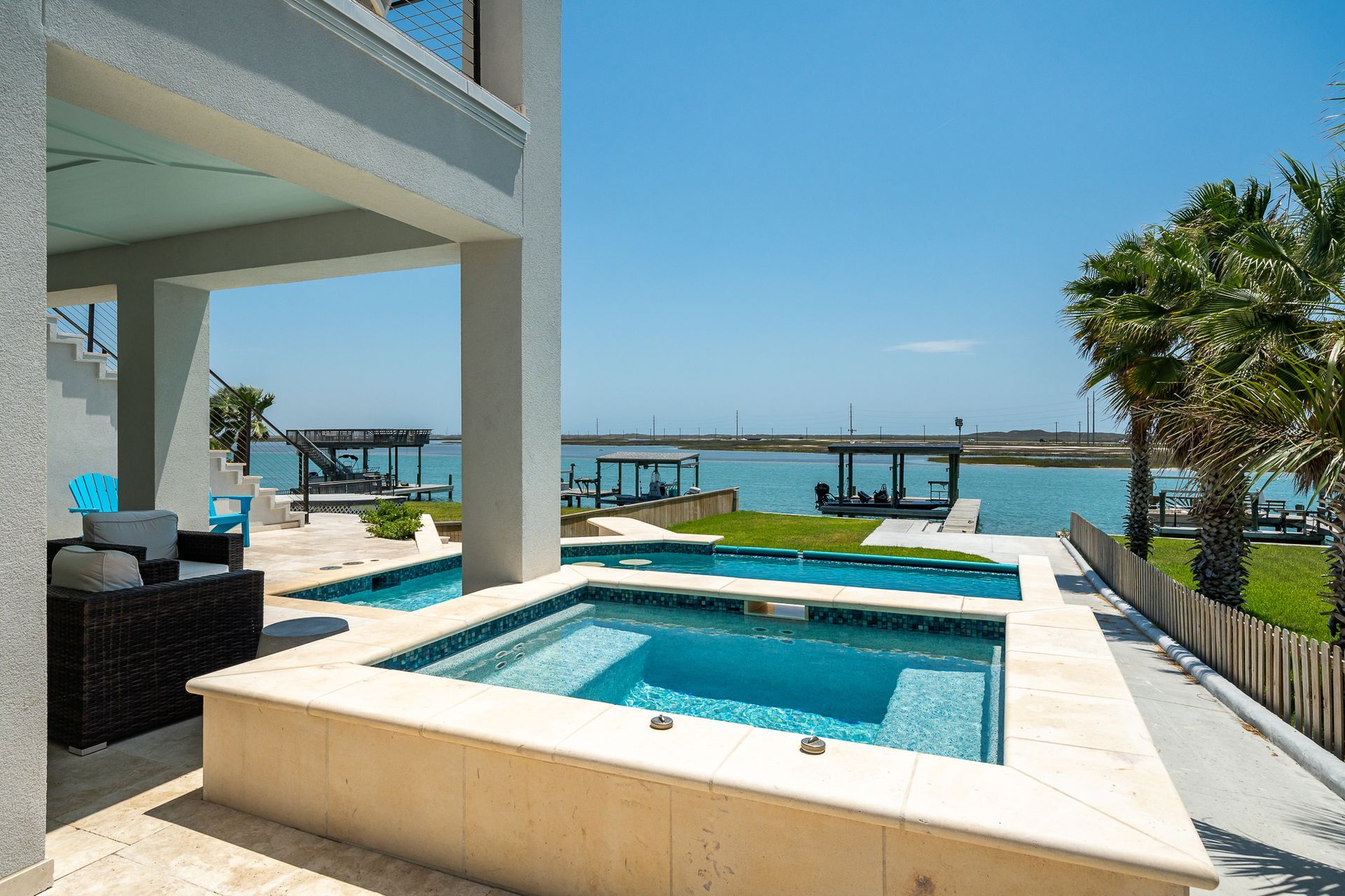 A large swimming pool with a view of the ocean