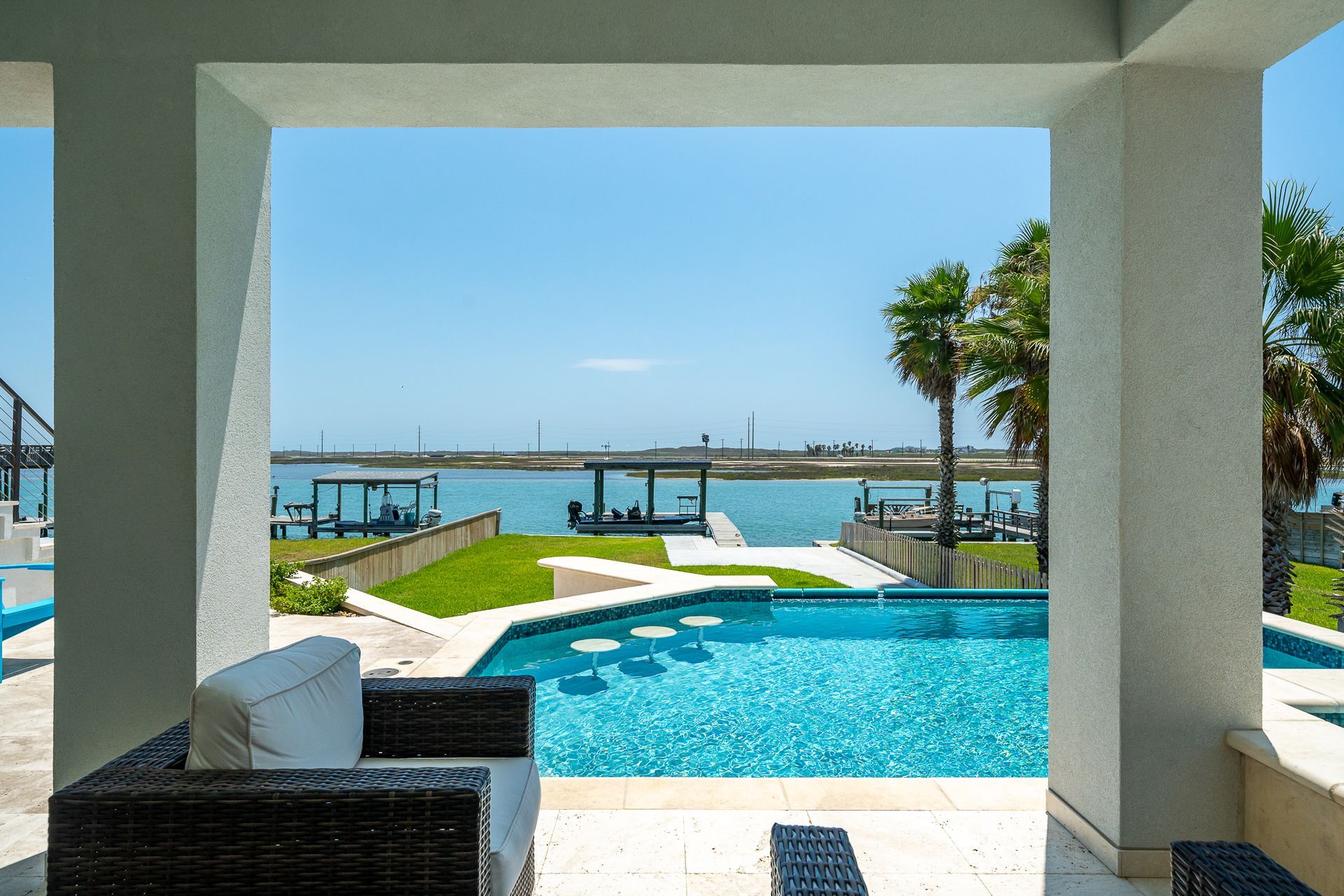 A view of a swimming pool with a dock in the background