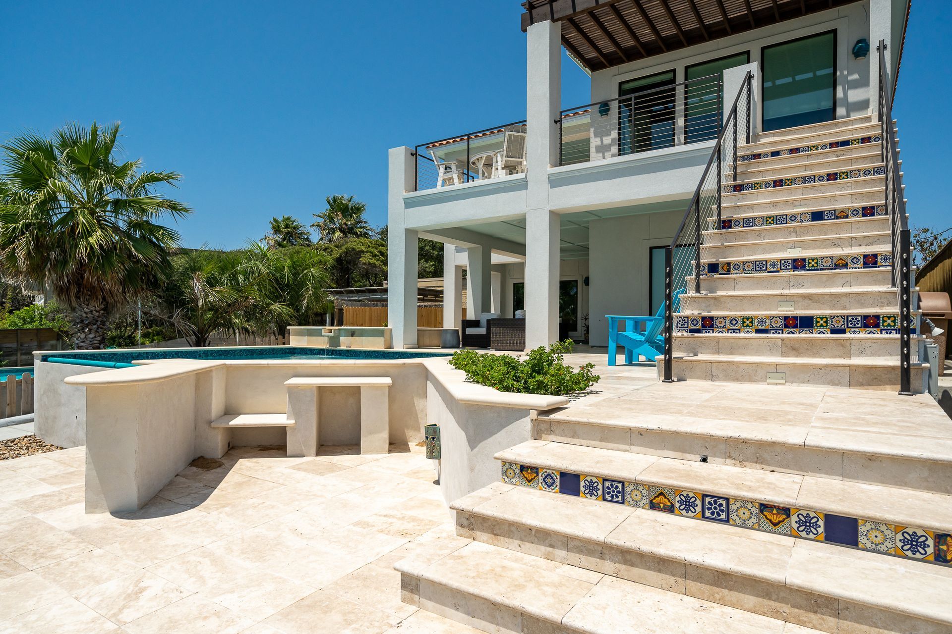 A large white house with stairs leading up to it