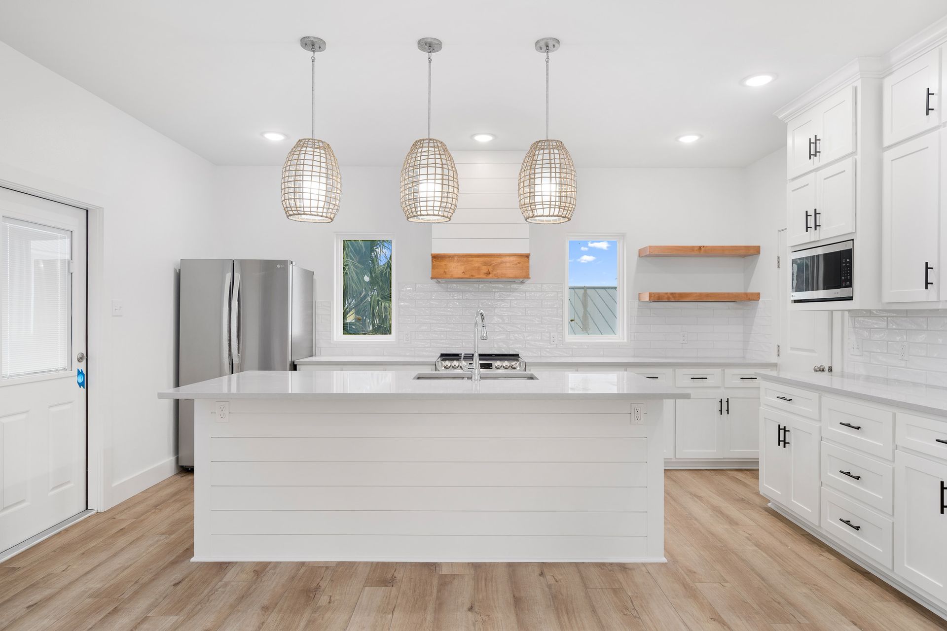 There is a large island in the middle of the kitchen.
