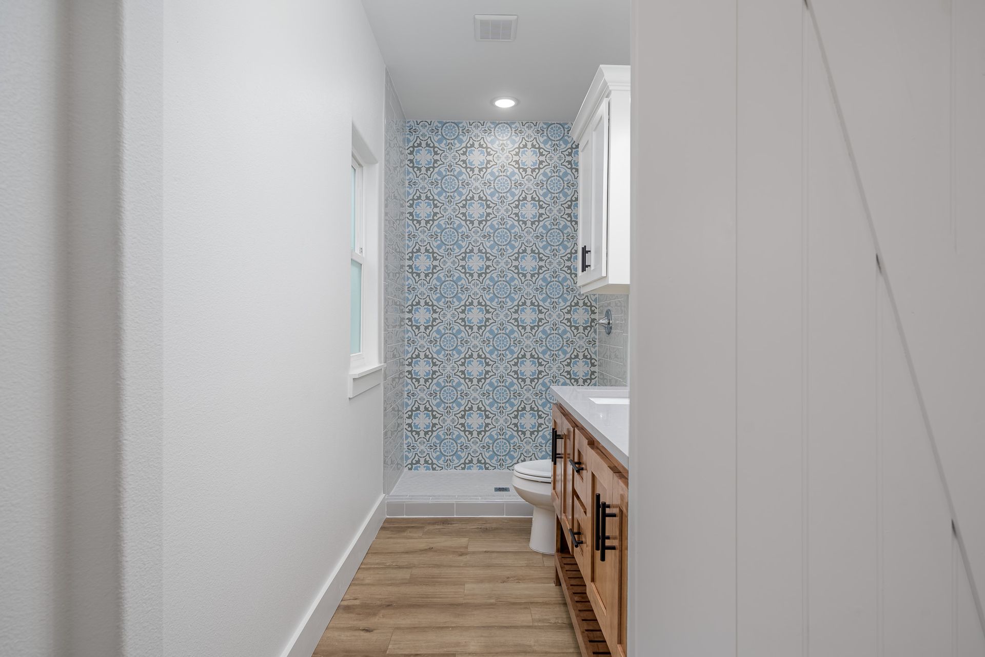 A bathroom with a toilet , sink , and shower.