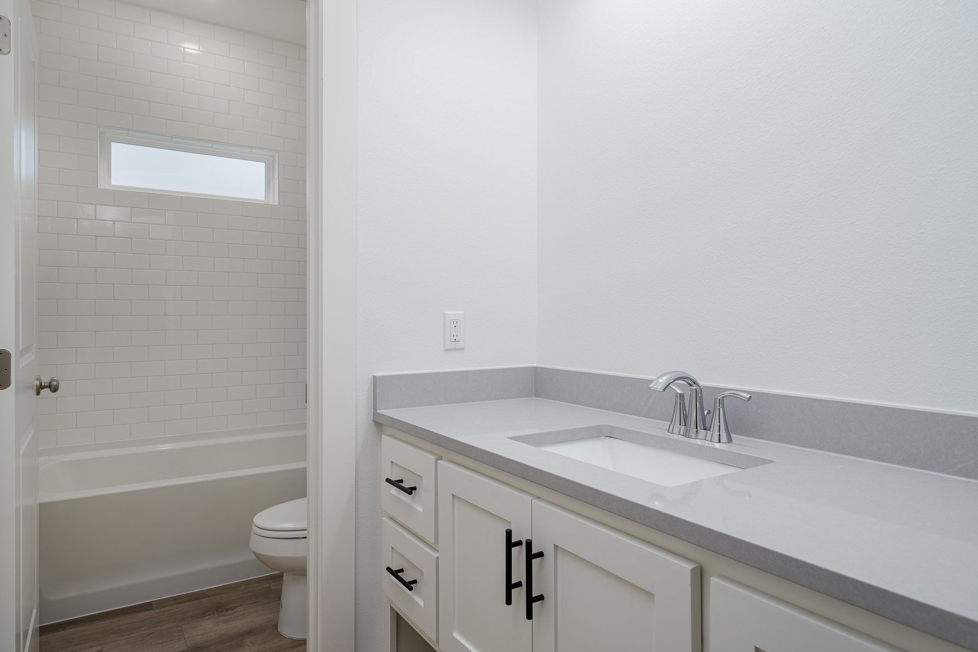 A bathroom with a sink , toilet and bathtub.