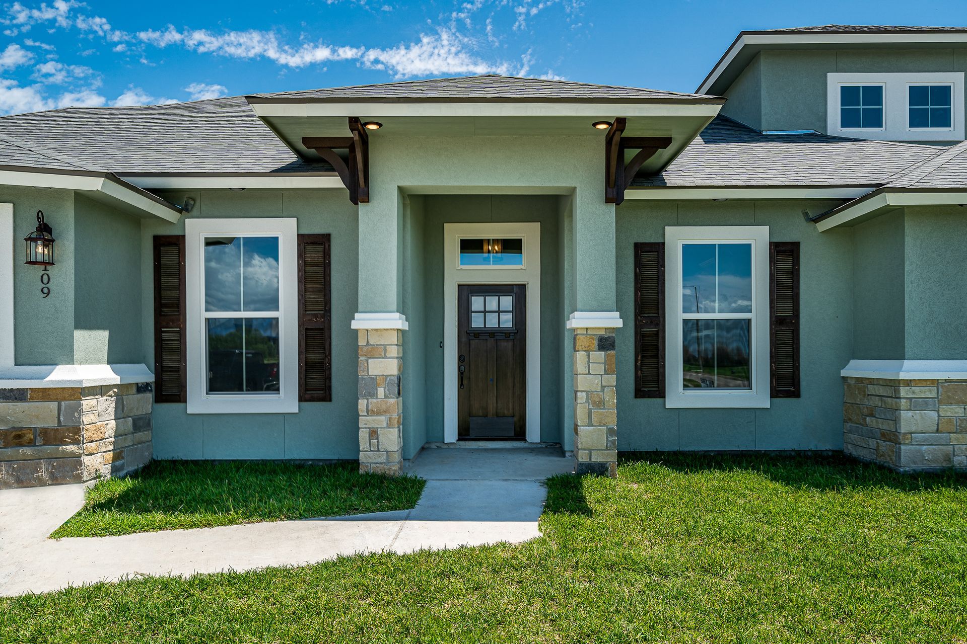 The front of a house with a lot of windows and shutters