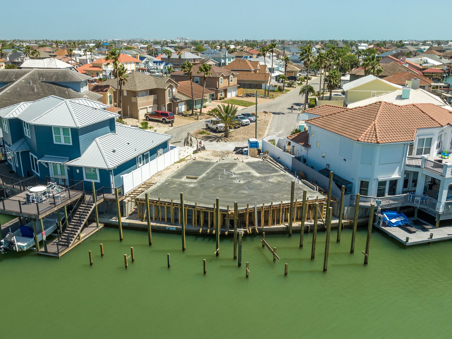 An aerial view of a residential area with houses and a dock