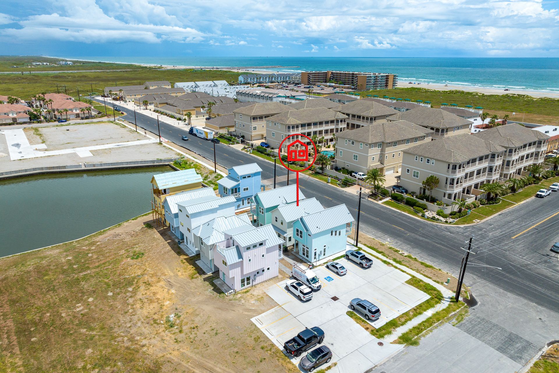 An aerial view of a residential area next to the ocean.