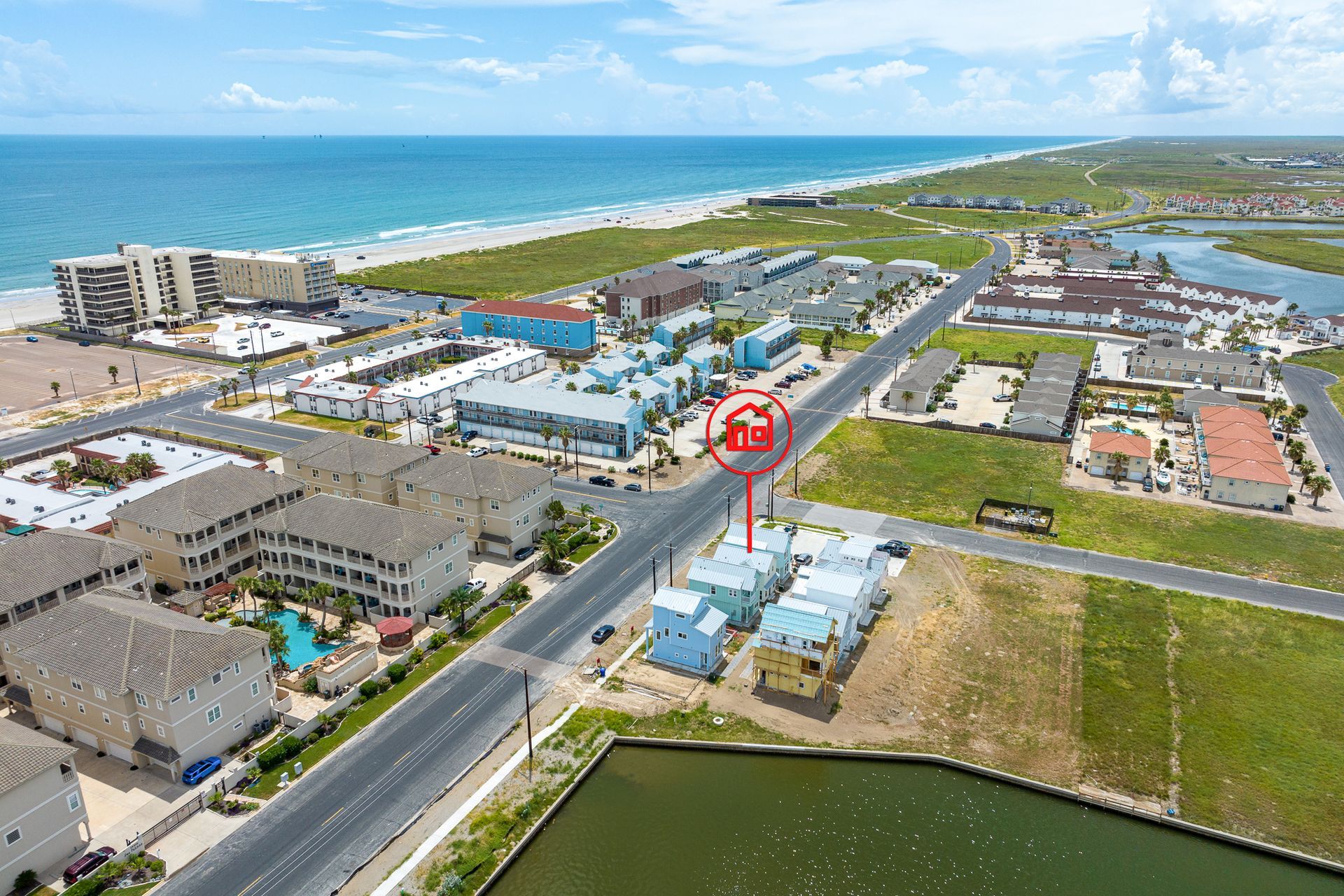 An aerial view of a residential area next to the ocean.