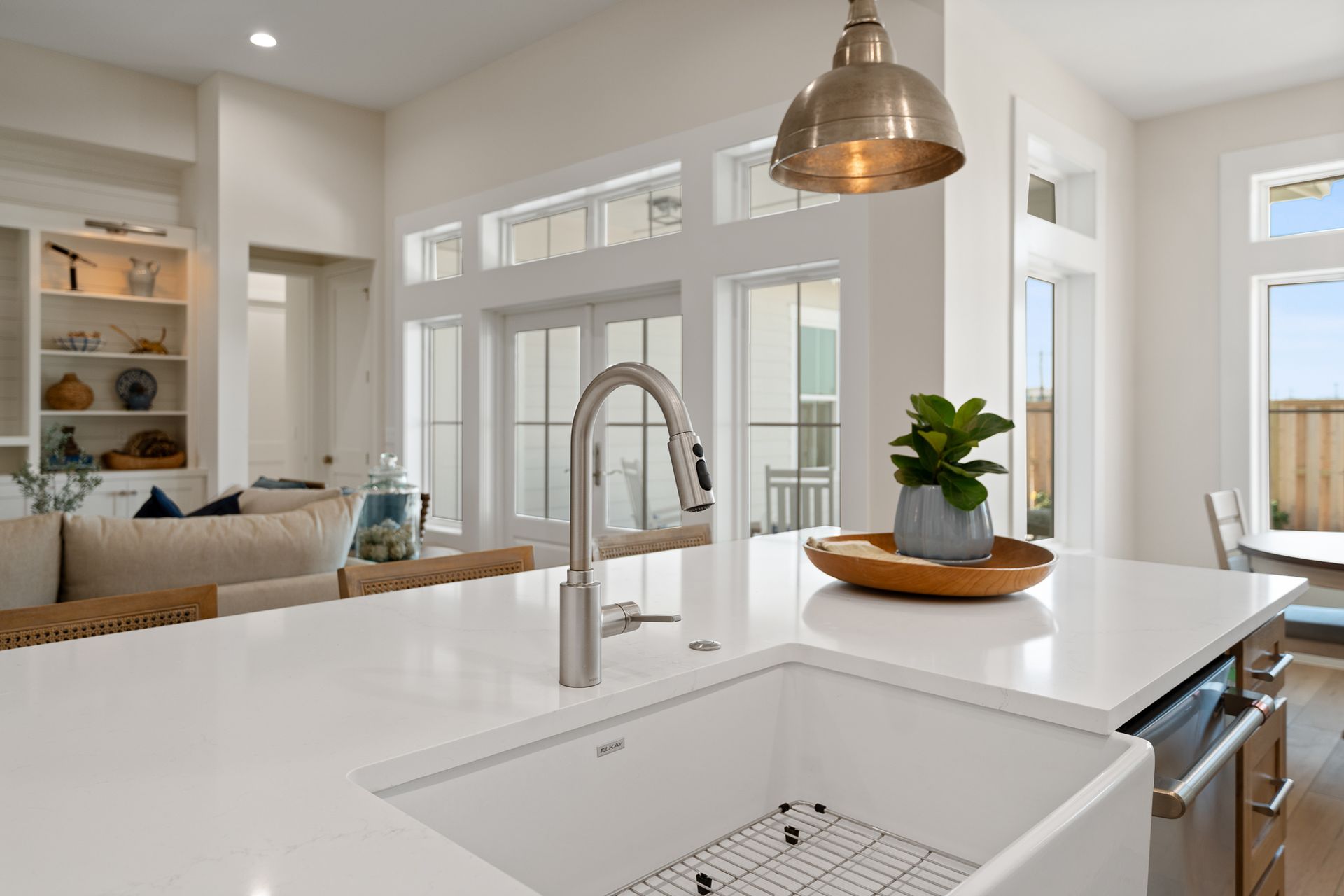 A kitchen with a white sink and a faucet.
