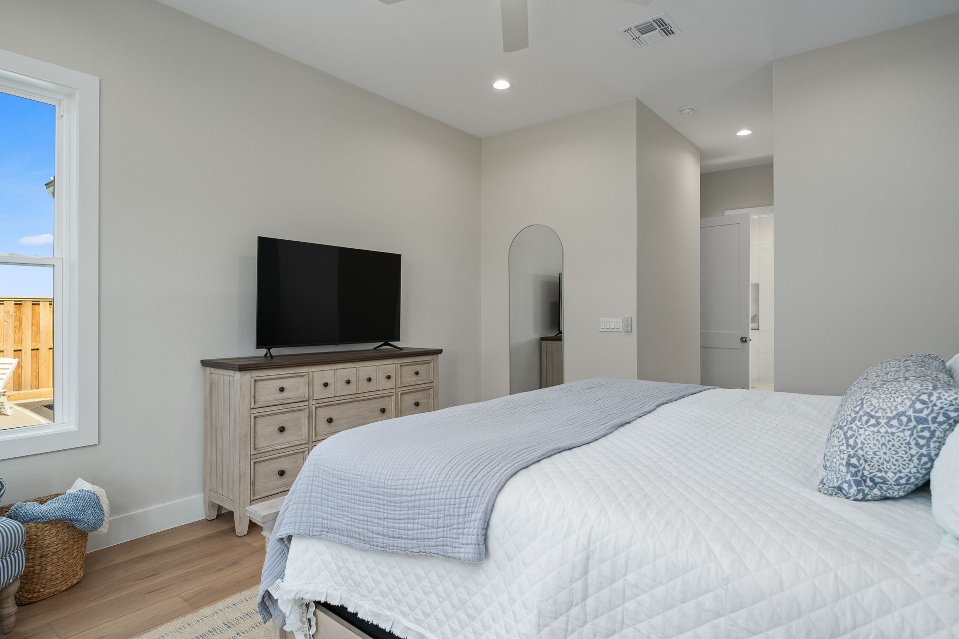 A bedroom with a bed , dresser , and television.