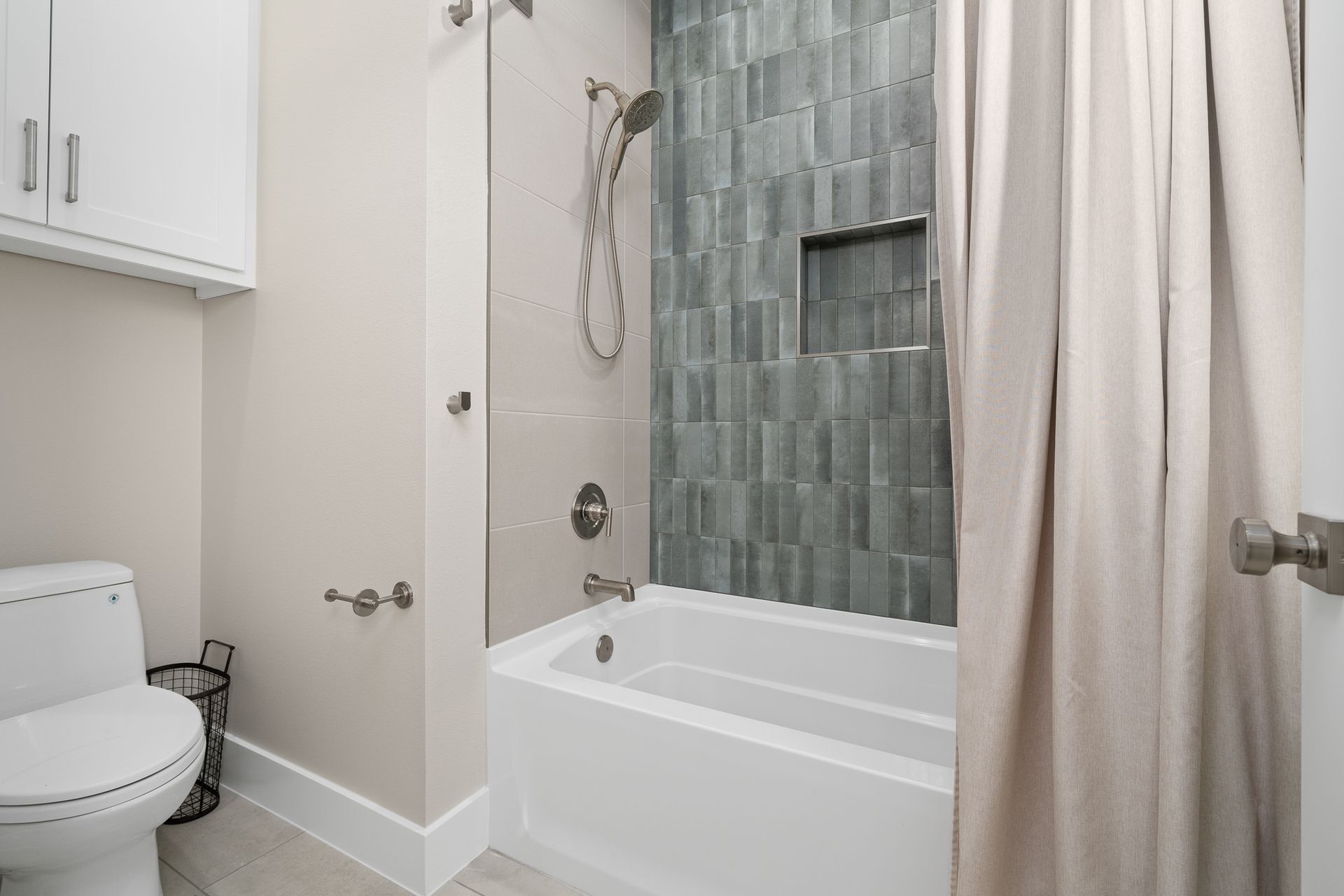 A bathroom with a toilet , tub and shower.