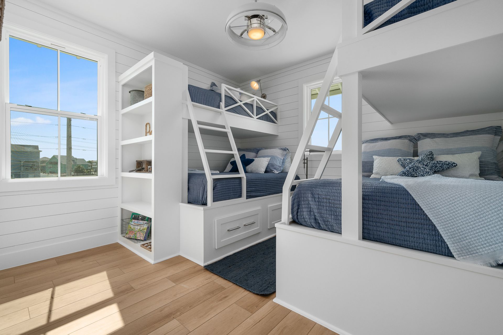 A bedroom with two bunk beds and a window.