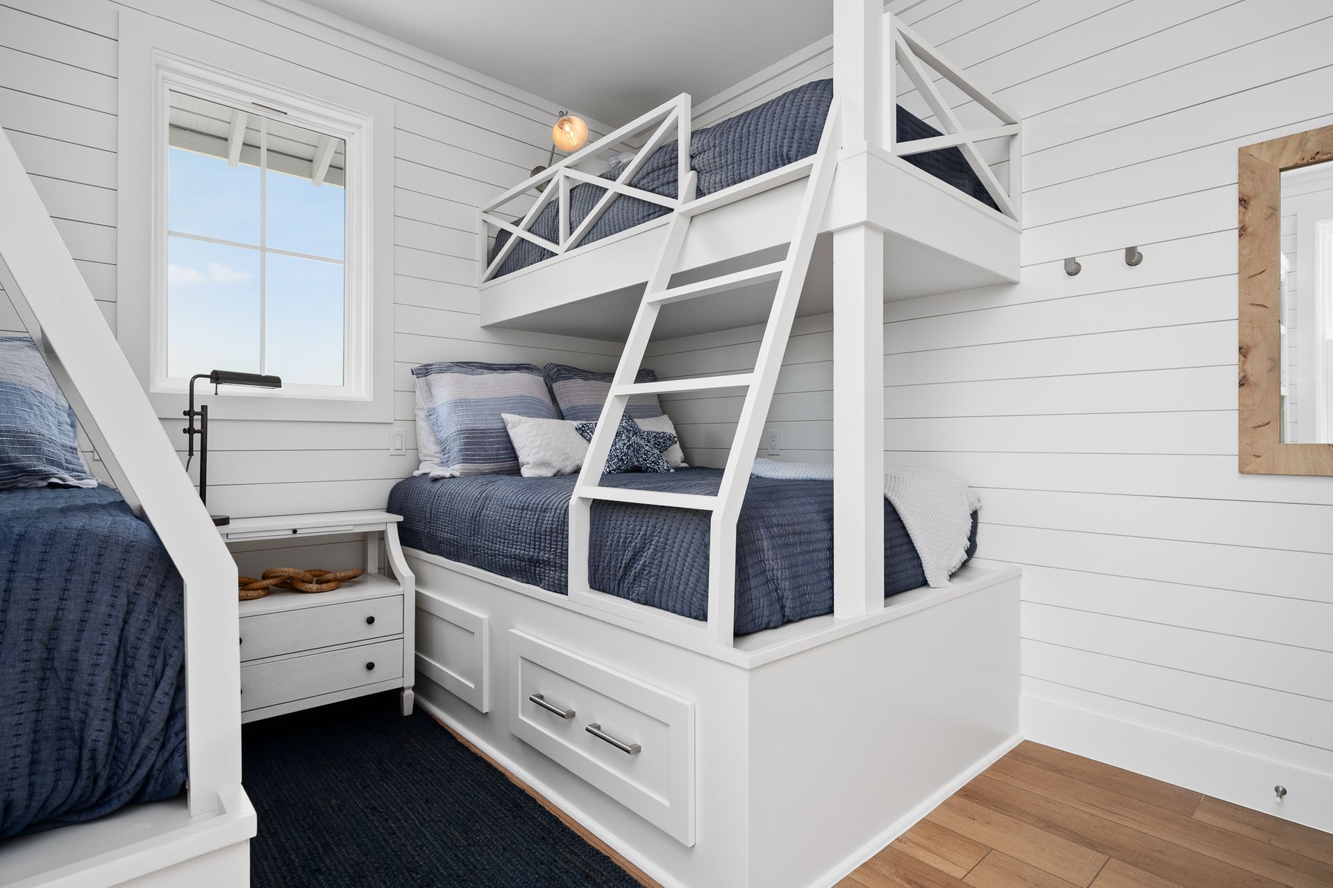 A bedroom with two bunk beds and a window.