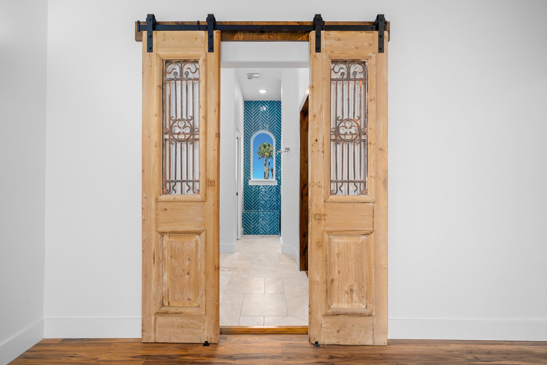 A room with a sliding barn door leading to a bathroom.