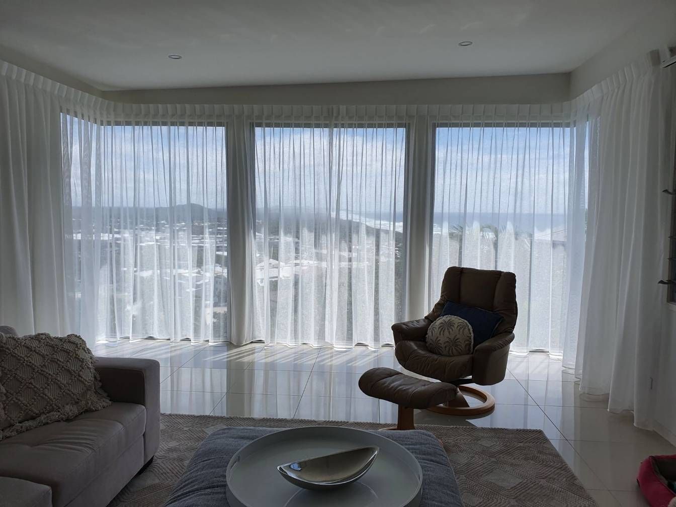 A Living Room With a Couch, Chair, Table and Curtains — Artizen Curtains in Mooloolaba, QLD