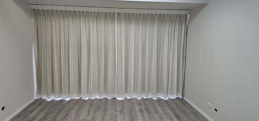 An Empty Room With a Large Window and White Curtains — Artizen Curtains in Mooloolaba, QLD